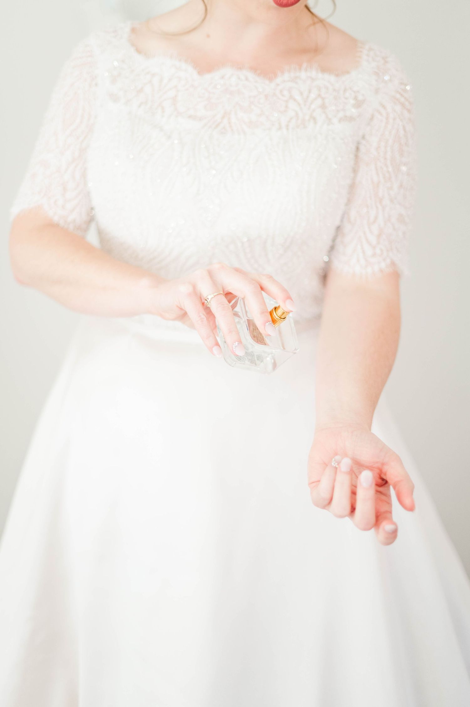 Bride puts on Perfume before her catholic wedding at St. Monica Catholic Church in Edmond, OK.