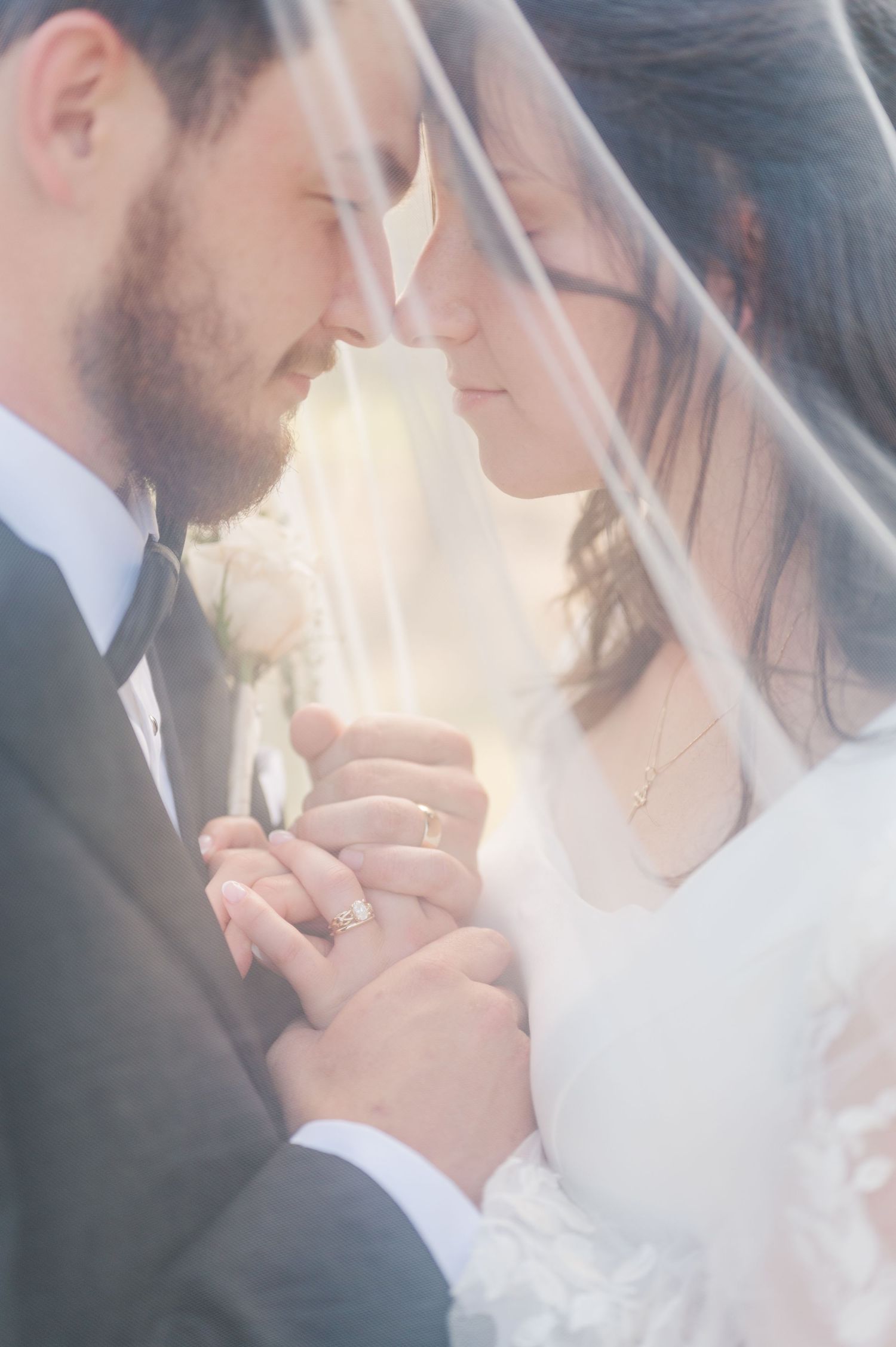 Bride and Groom under wedding veil portrait during summer time Wedding at camp Loughridge in Sapulpa, OK.