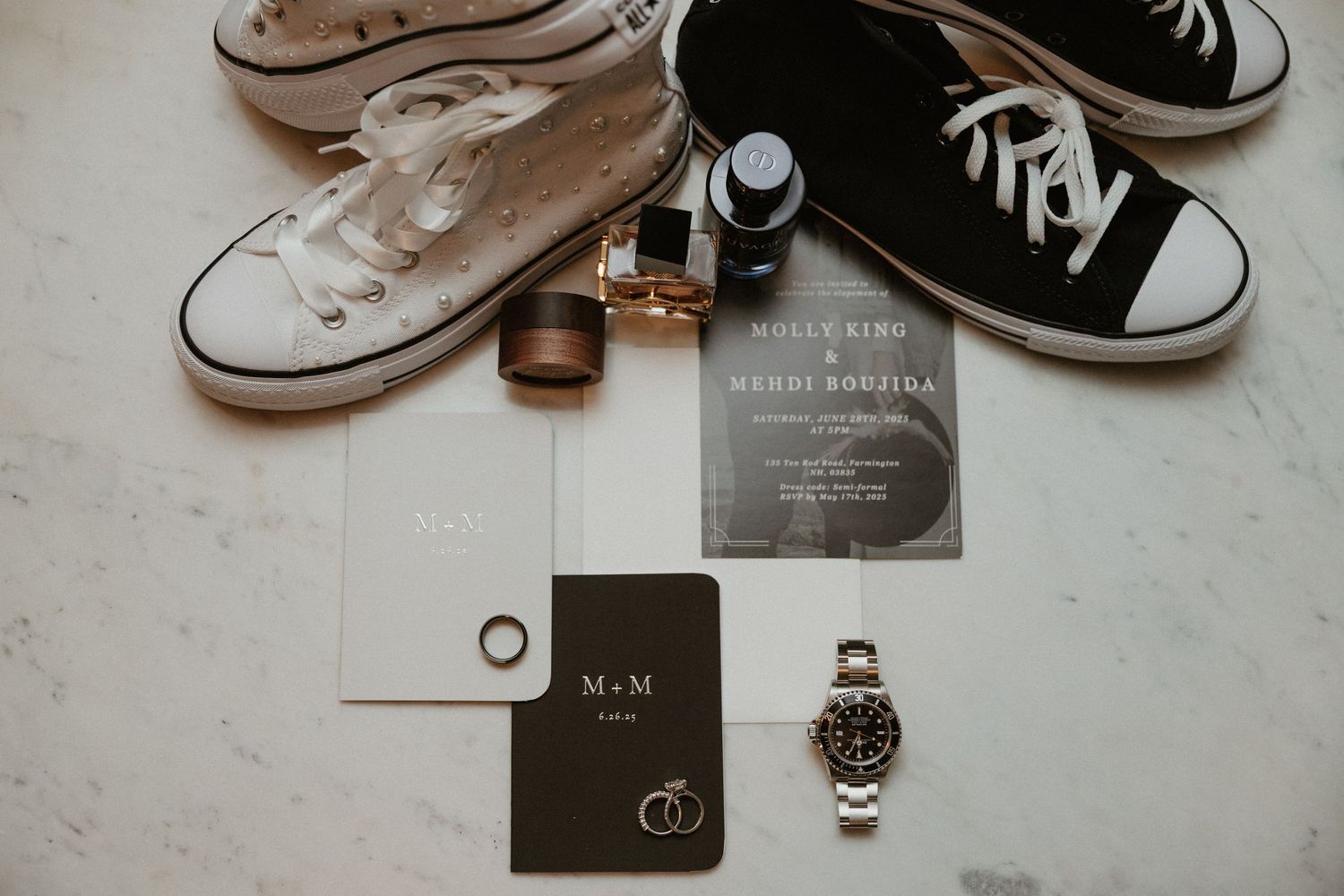 Wedding accessories including sneakers, rings, and invitation cards arranged in a flat lay composition.
