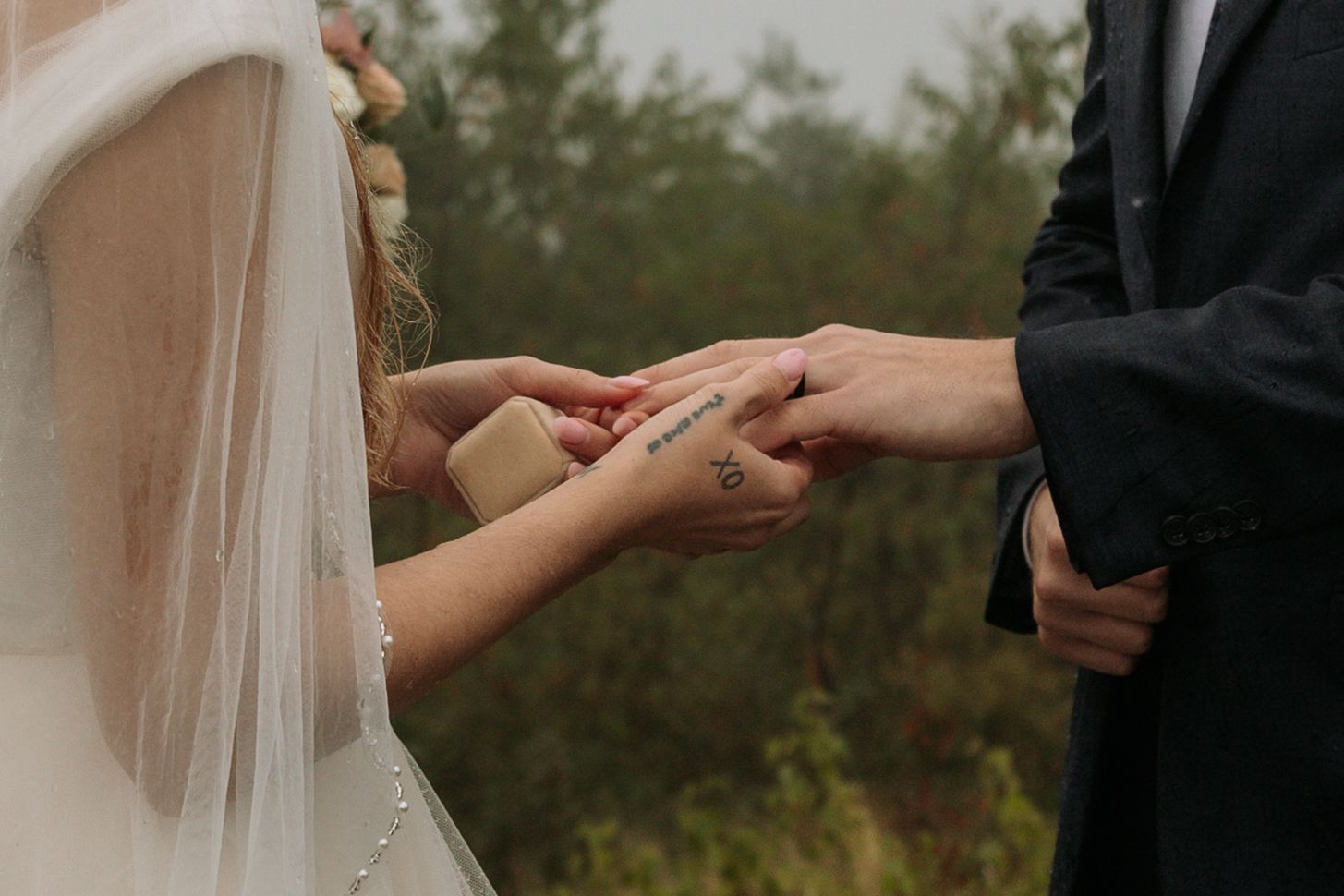 bride putting ring on groom