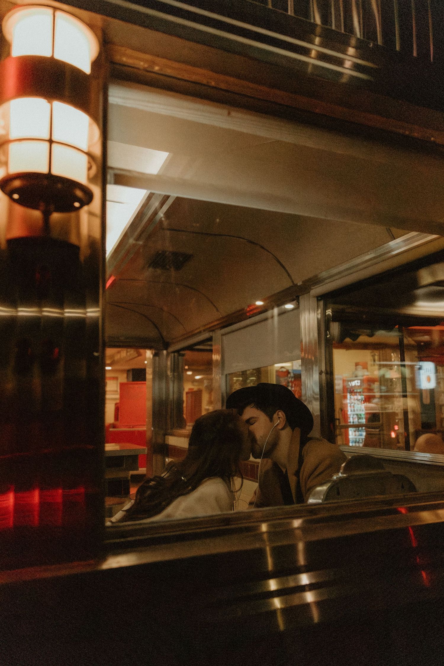 An intimate moment captured in a dimly lit vintage interior space.