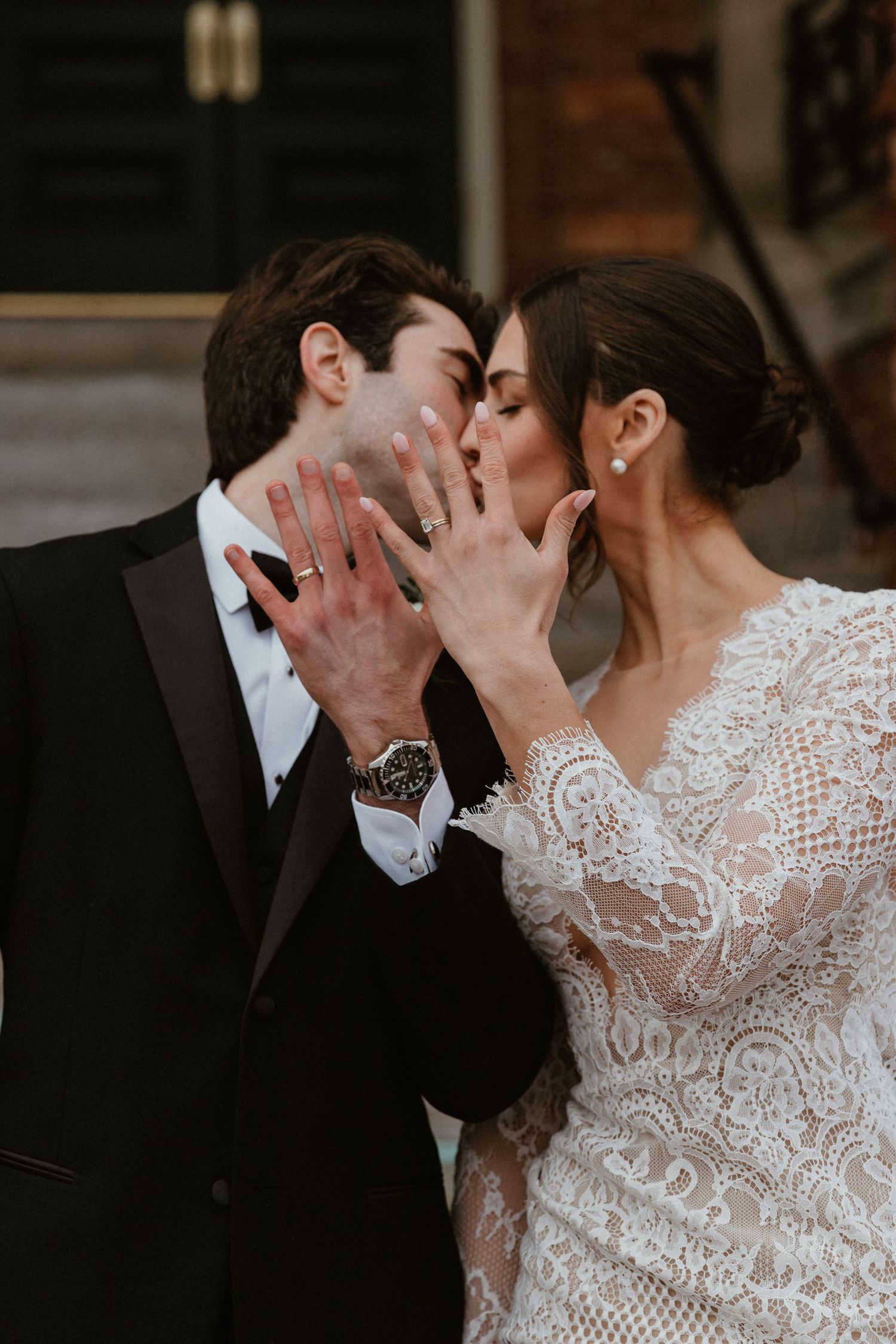 A close-up shot of newlyweds sharing an intimate moment in formal wedding attire.