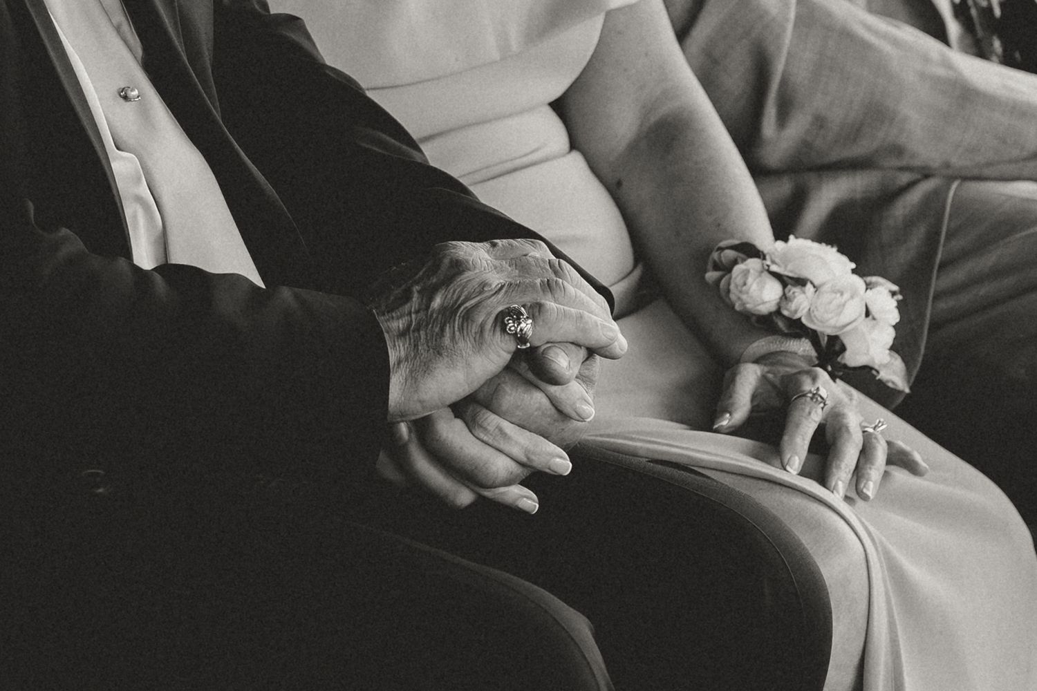 Close-up shot of hands exchanging wedding rings during an intimate ceremony.