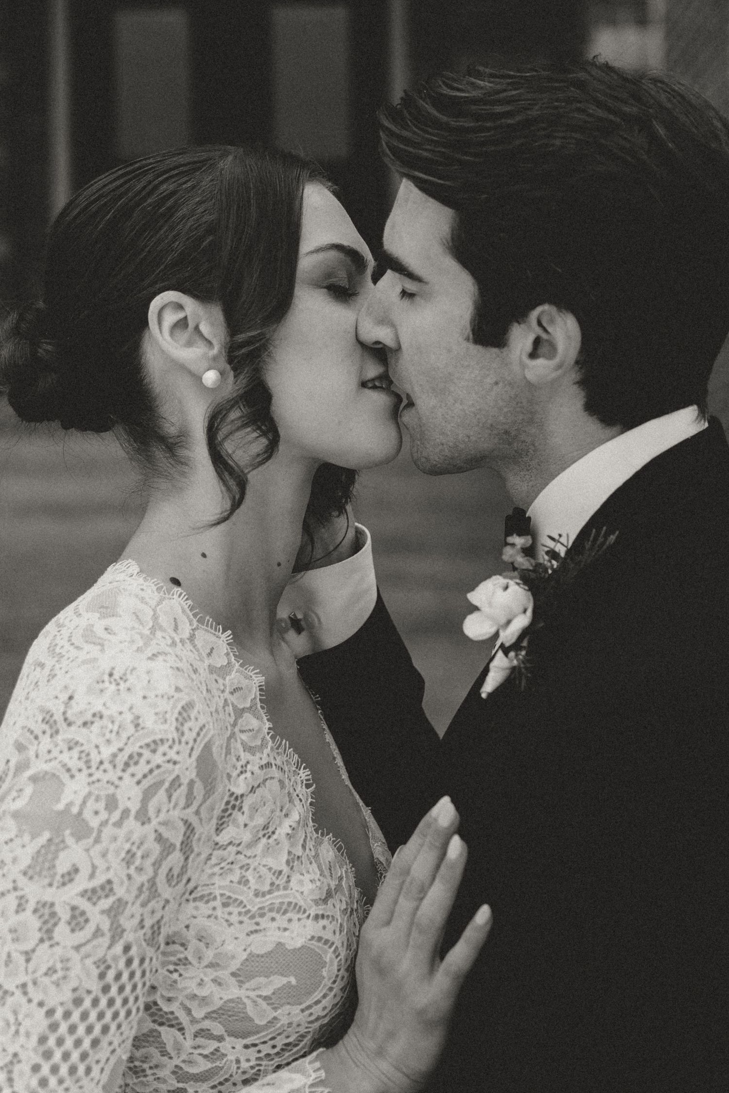 An intimate black and white portrait of a romantic wedding kiss.