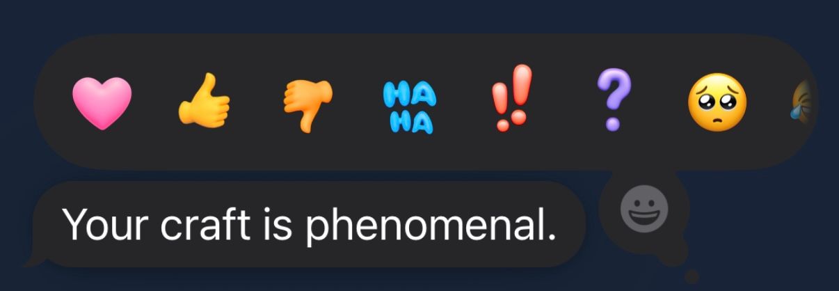 A row of colorful emoji reaction buttons including heart, thumbs up, thumbs down, and question mark icons against a dark background.
