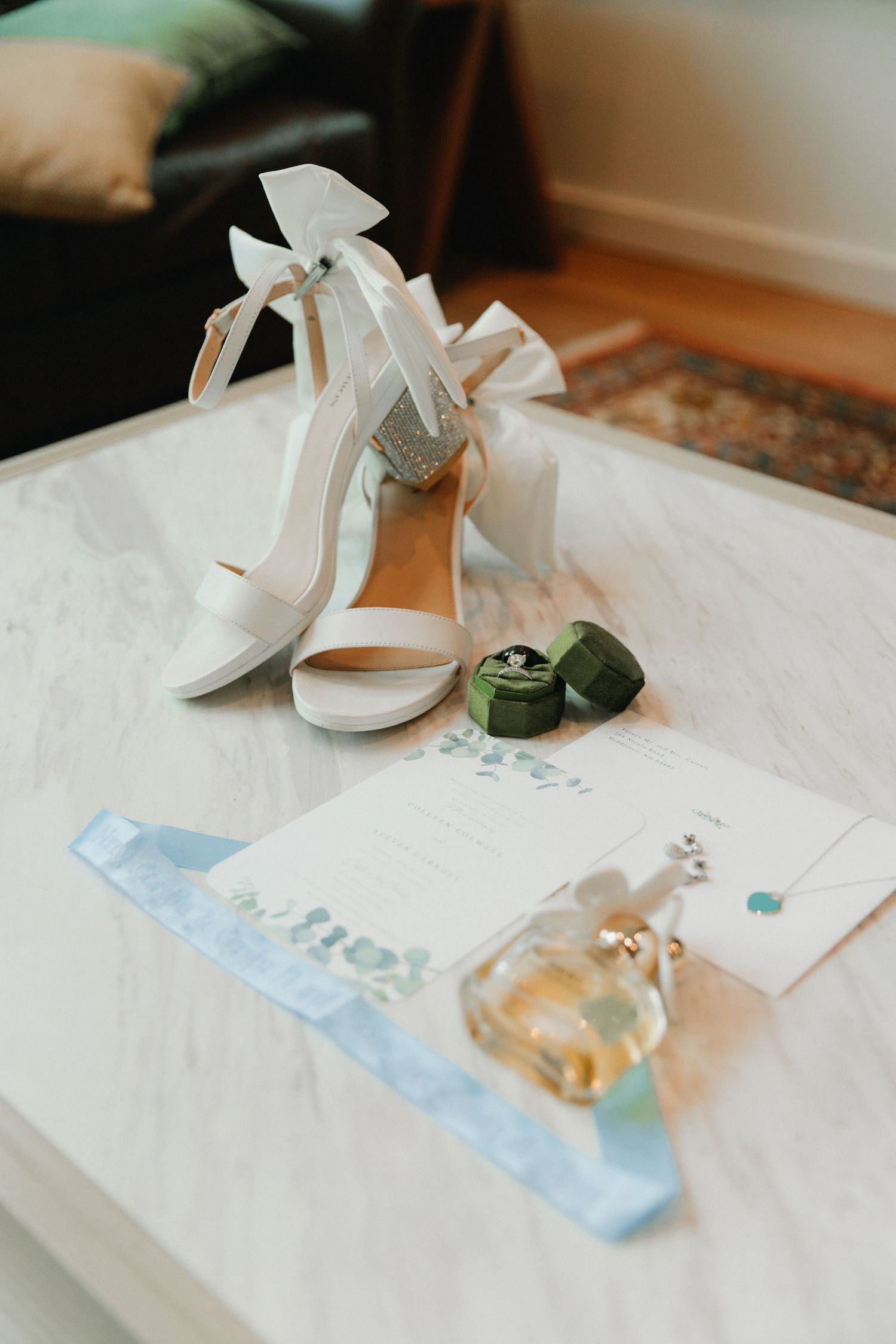 Elegant white bridal shoes and wedding accessories arranged on delicate paper with watercolor details.