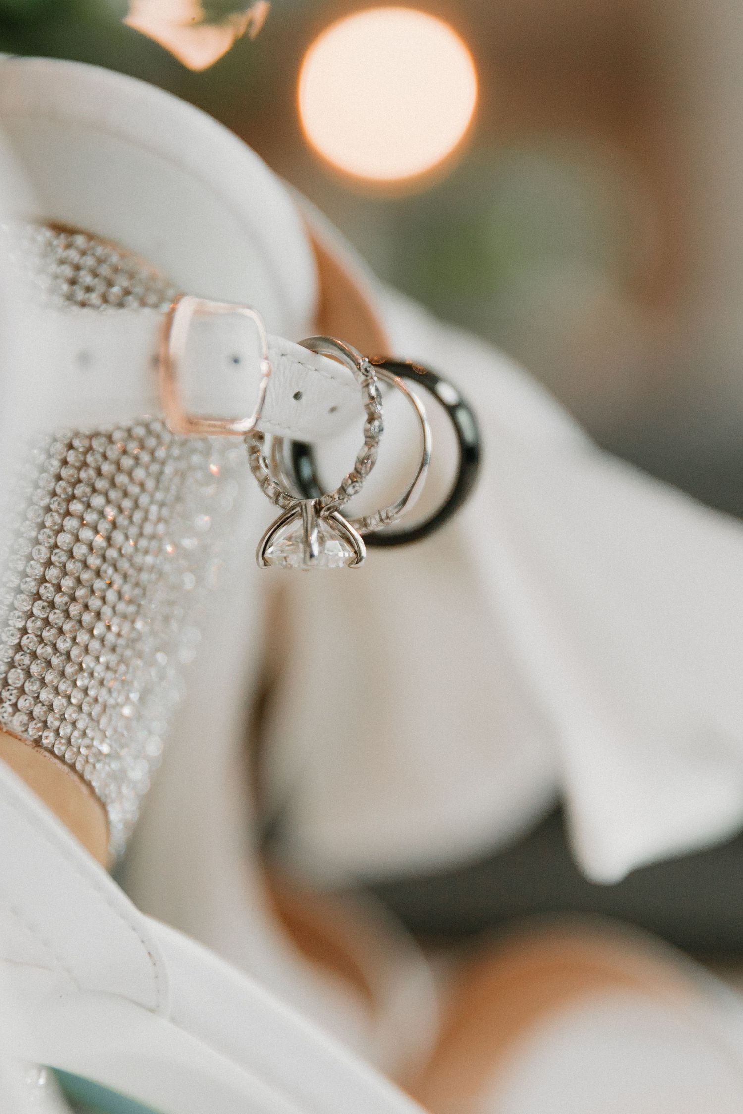 Close-up of intricate beading details on white wedding attire.