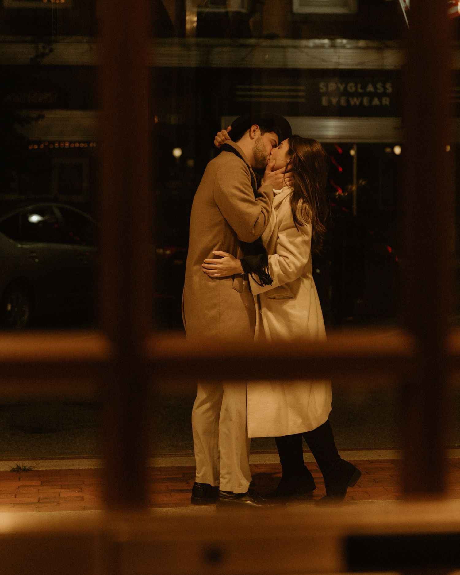 A tender moment shared in a warmly lit indoor setting with wooden details.