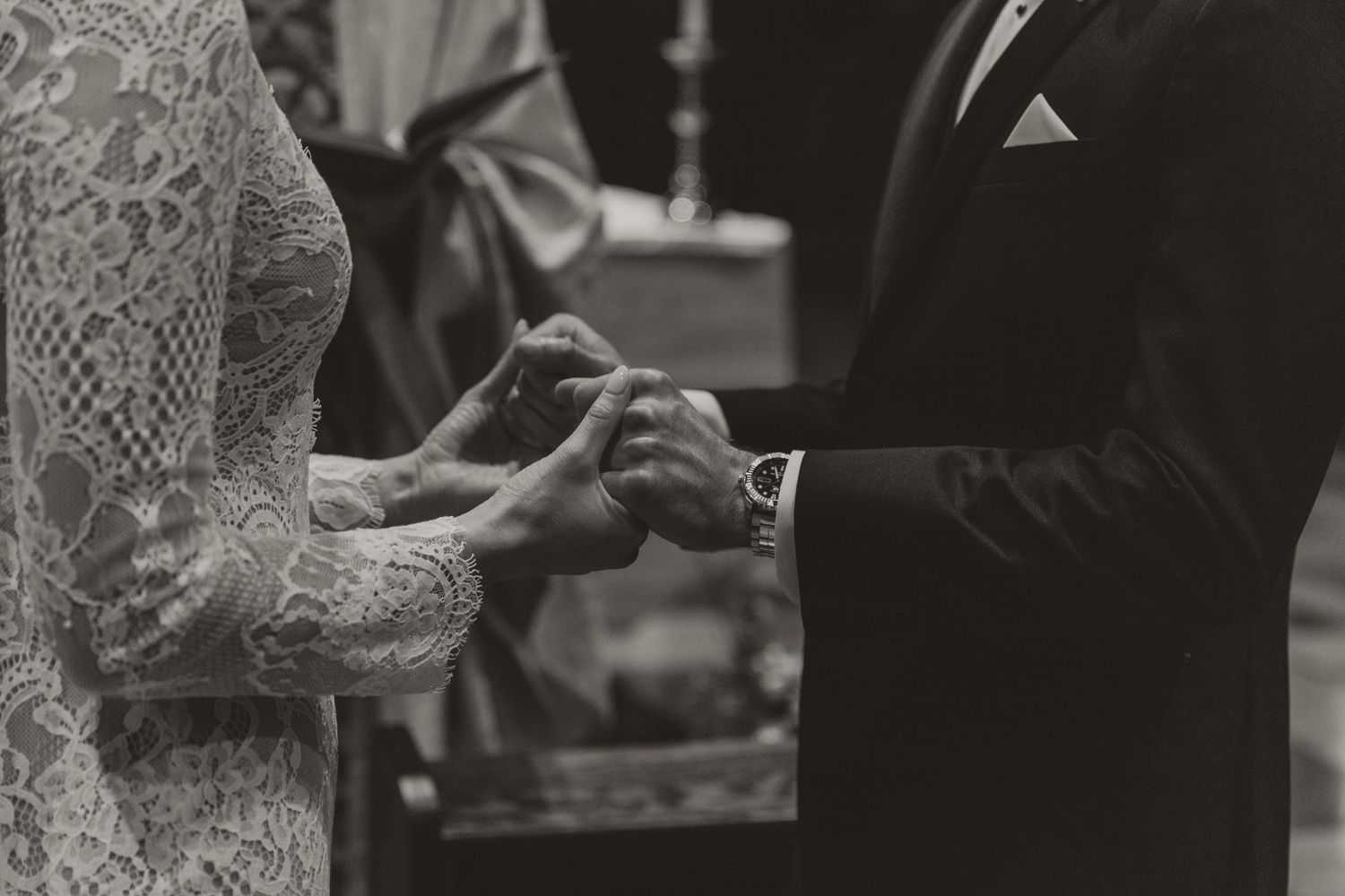 Close-up of hands exchanging rings during wedding ceremony.