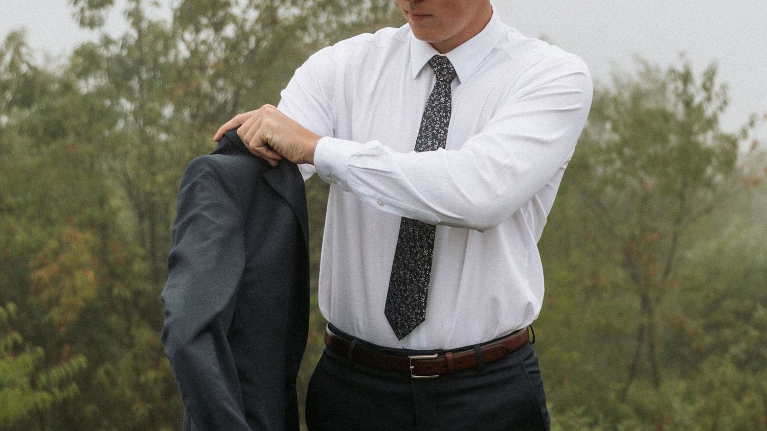 groom putting jacket on