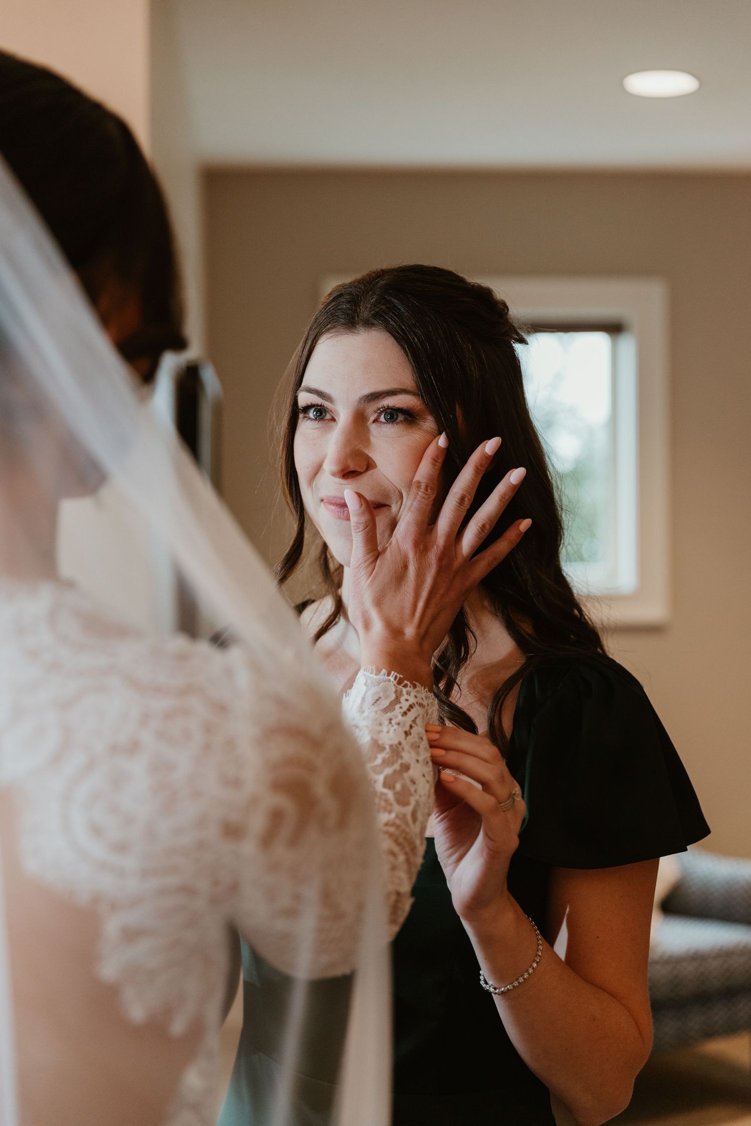 An emotional reaction during wedding preparations as someone shows off their ring.