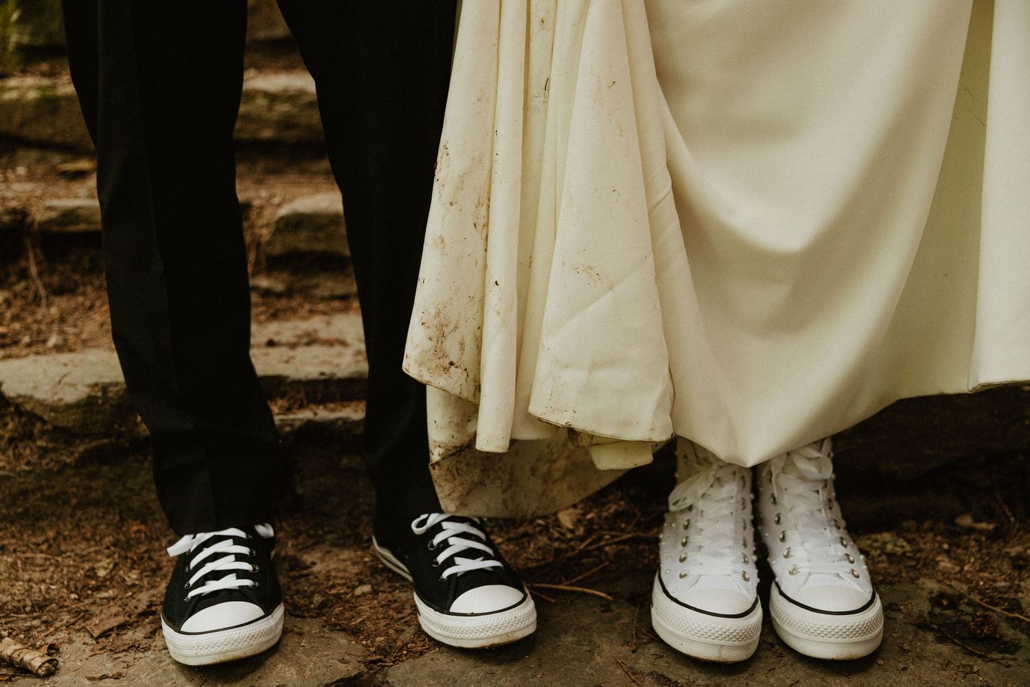Black and white Converse sneakers worn with formal wedding attire.