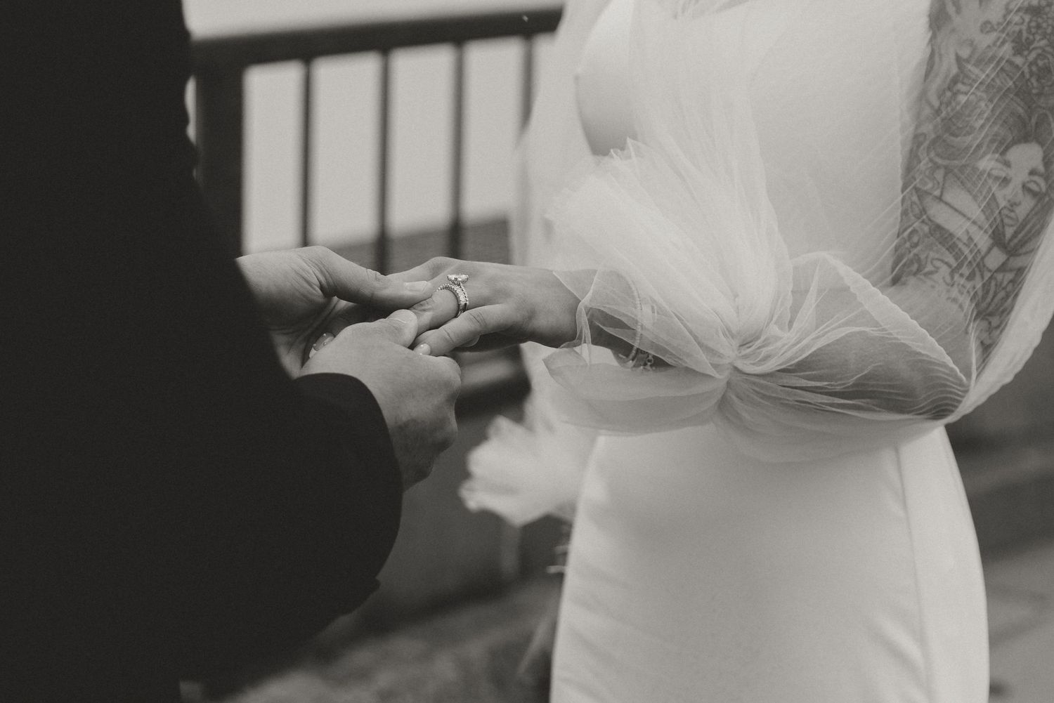 Elegant white wedding dress details against neutral background.