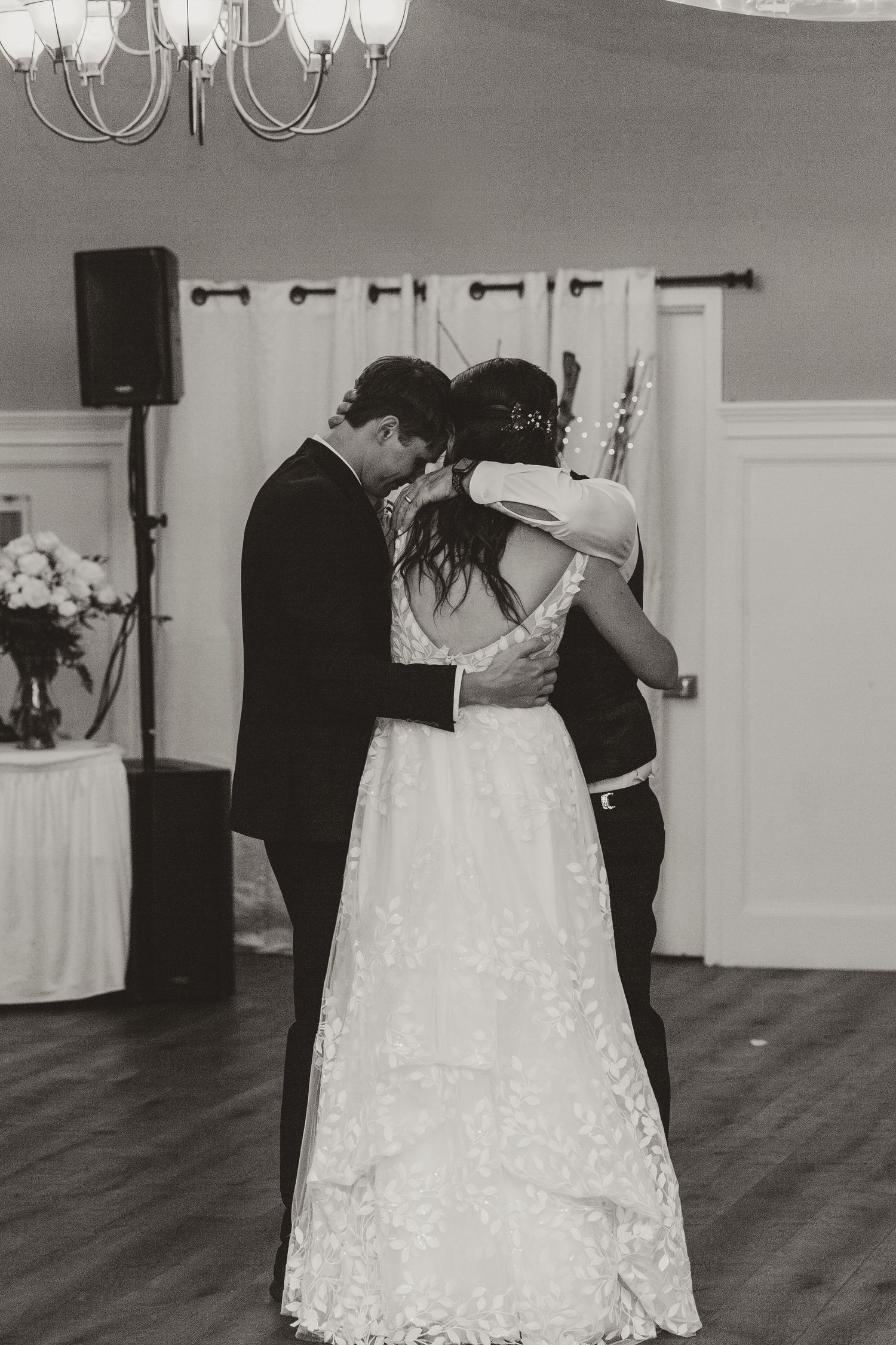 Black and white photos of a first dance in an elegant reception venue.