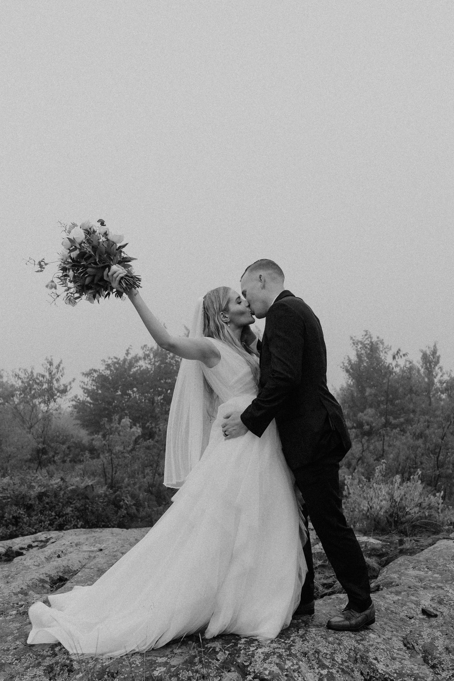 bride and groom celebratory kiss