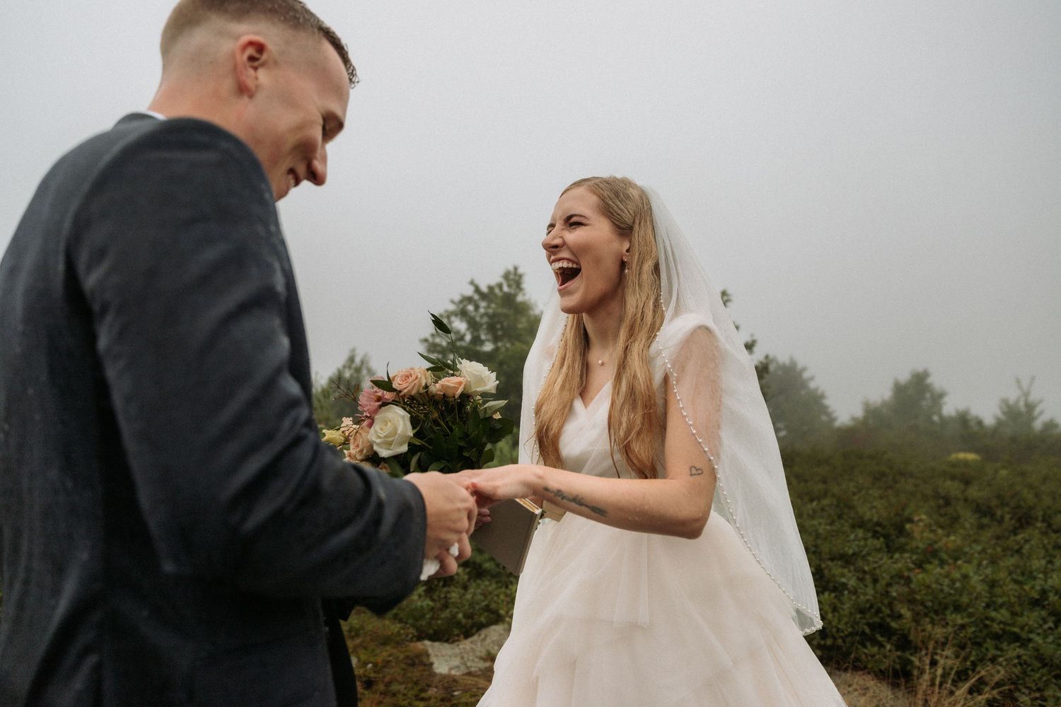 groom putting ring on bride