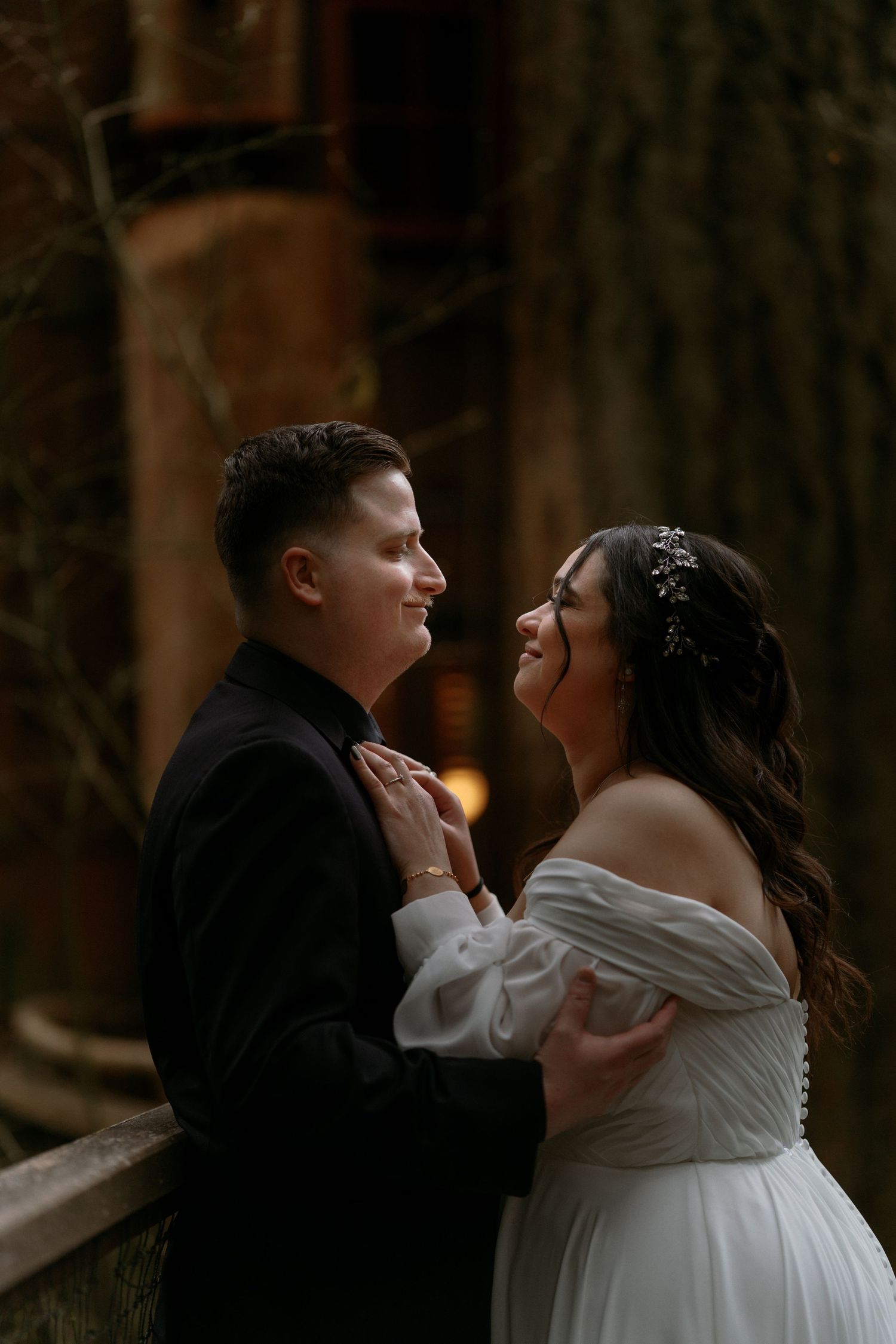 Happy couple sharing a joyful moment together at their romantic outdoor forest wedding ceremony.