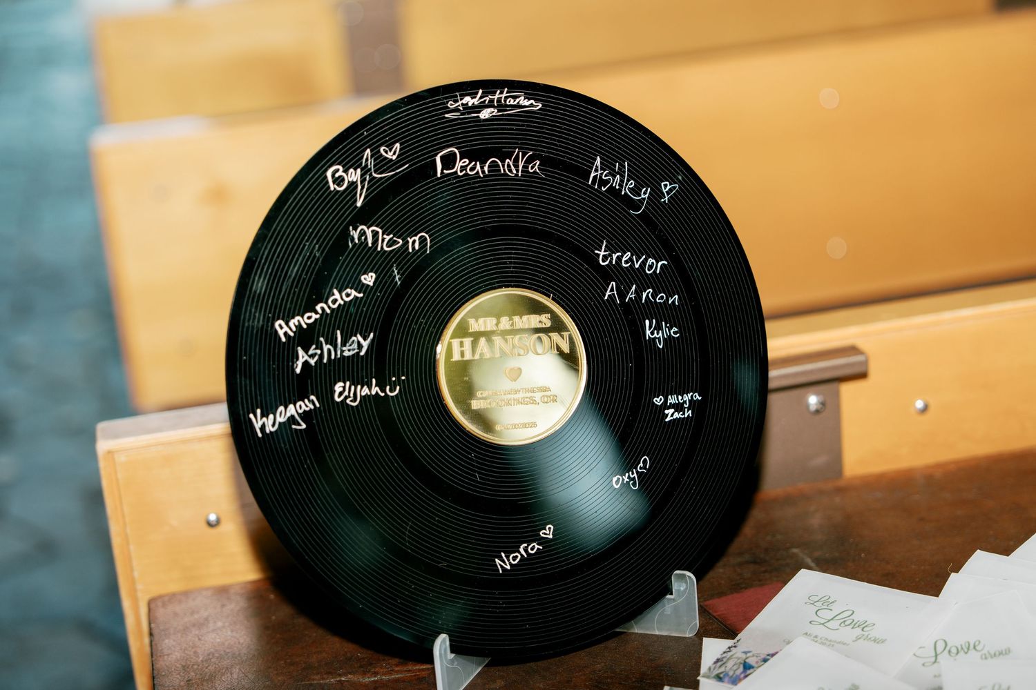 Hanson vinyl record used as a unique wedding guest book with signatures.