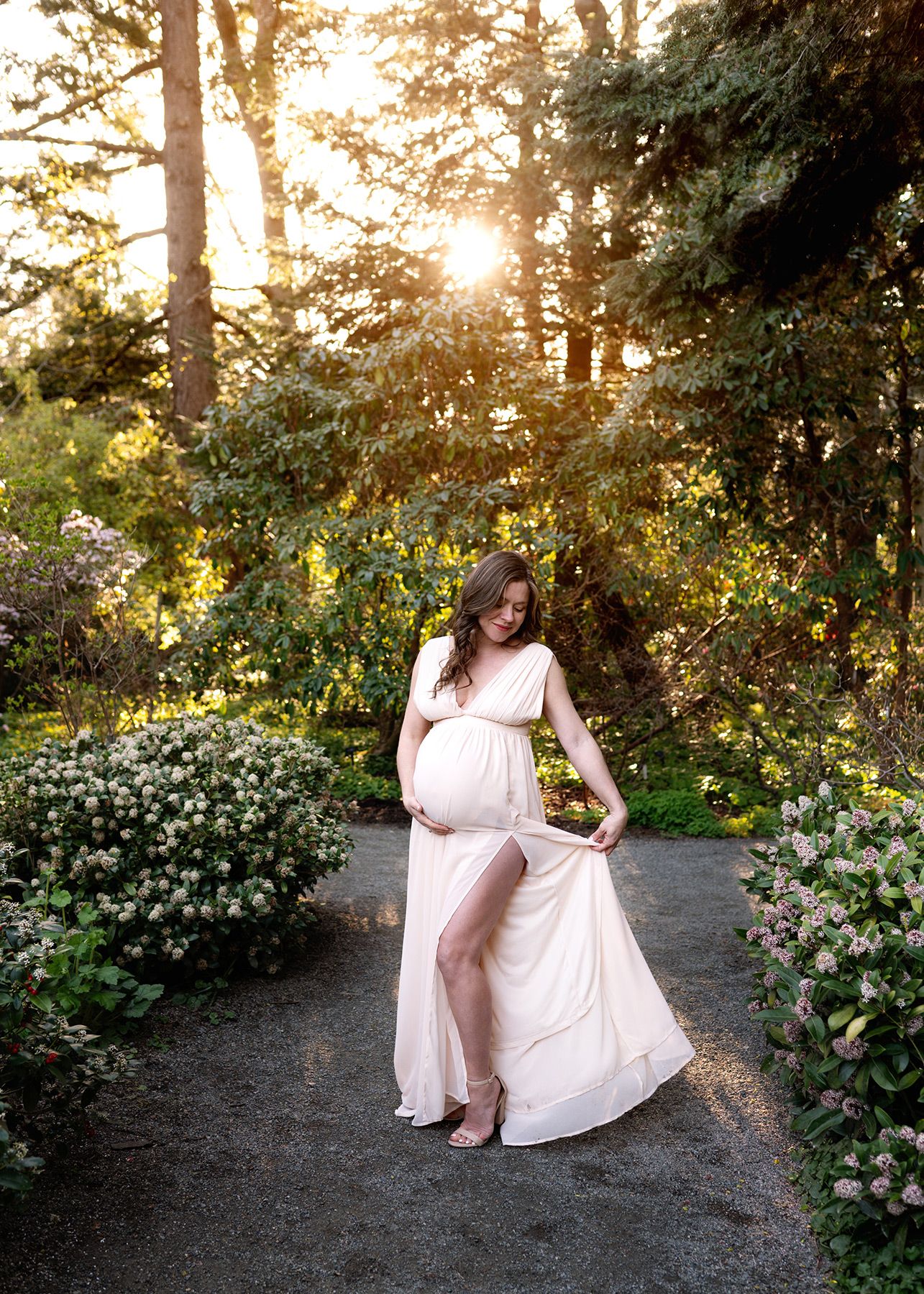 Pregnant mother in flowing dress standing in a sunlit garden, Victoria BC Maternity photography