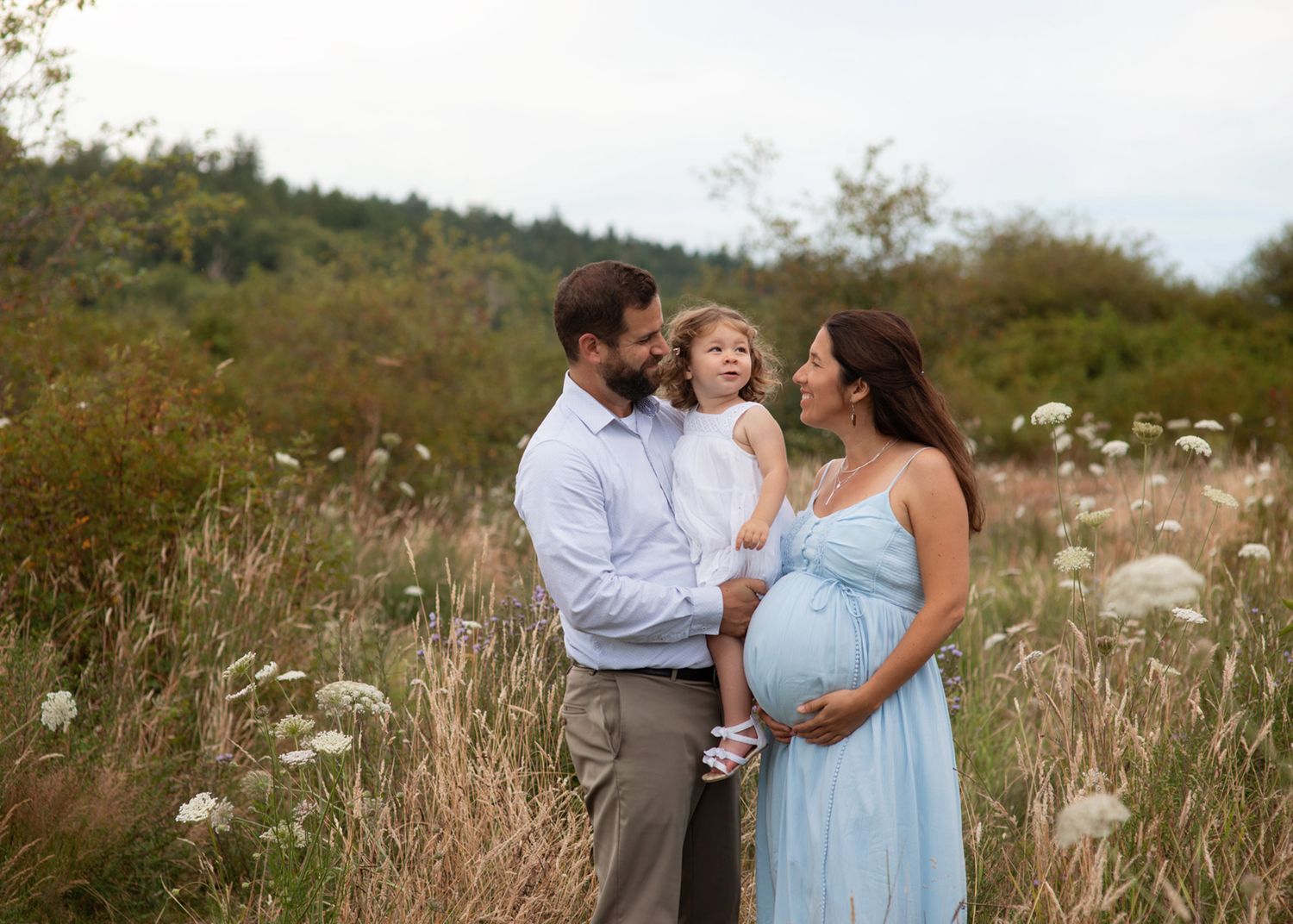 Expecting parents with toddler in a blooming field, natural light, Victoria BC maternity session