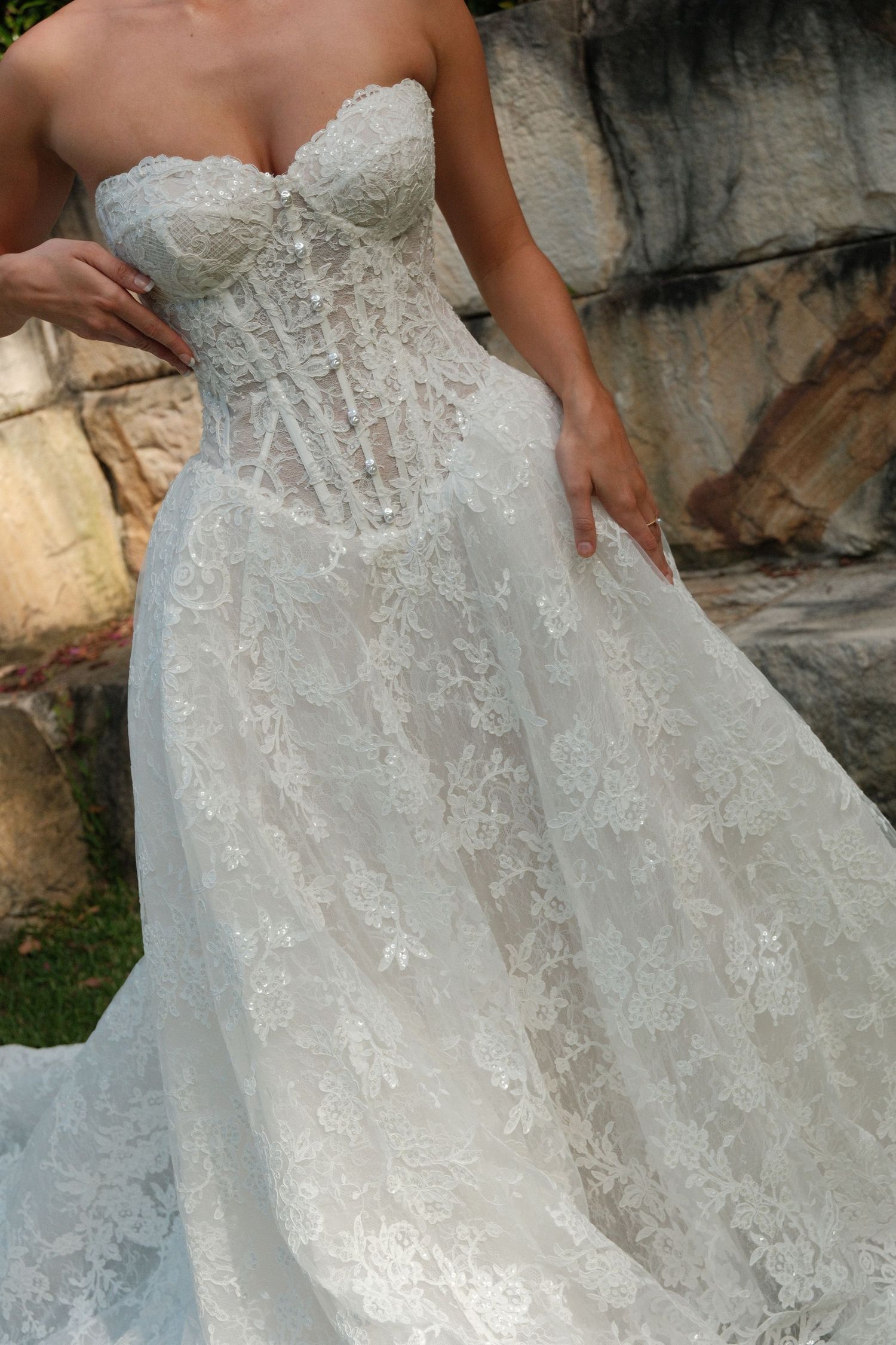 Close-up details of a white lace wedding dress with intricate floral embroidery and beading shown from multiple angles.