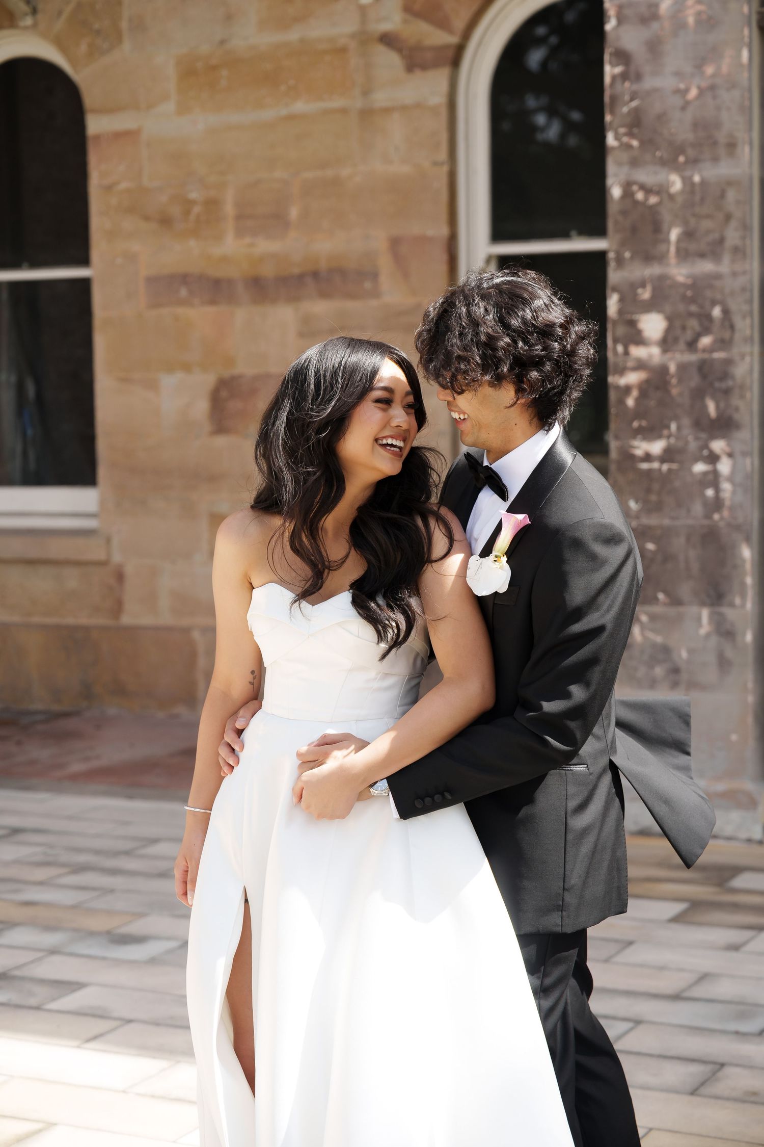 Elegant couple in white and black formal wear sharing romantic moments.