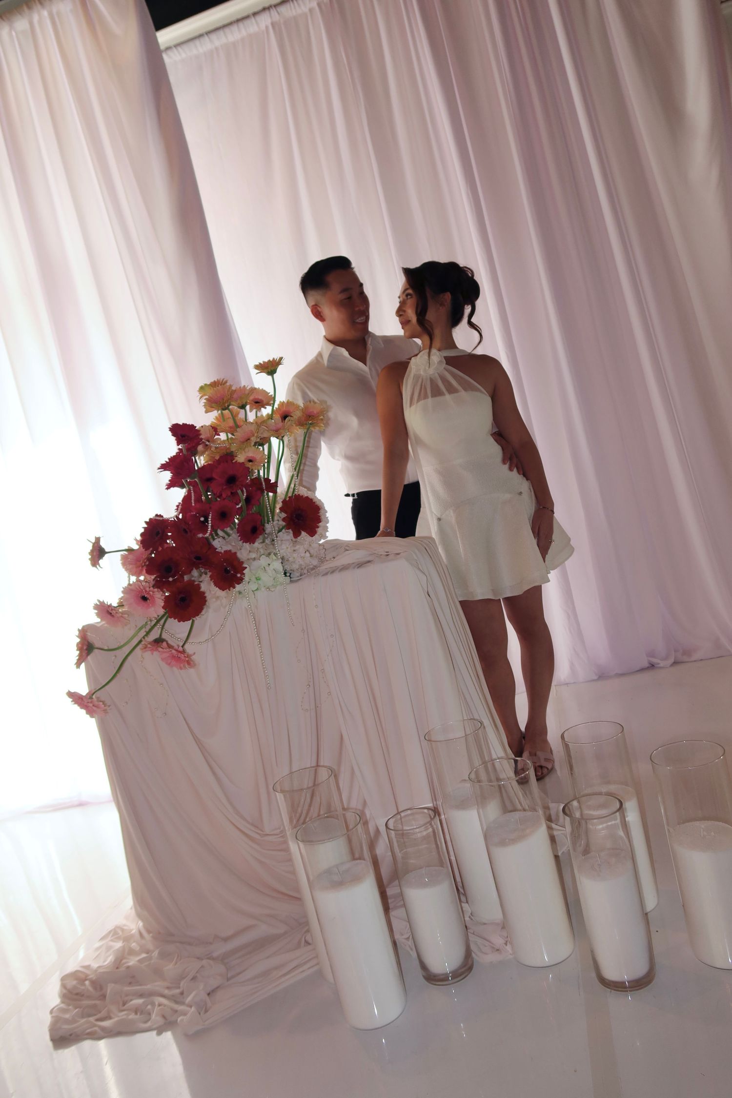 A series of elegant white wedding photos showing floral arrangements and decor against a soft white backdrop.