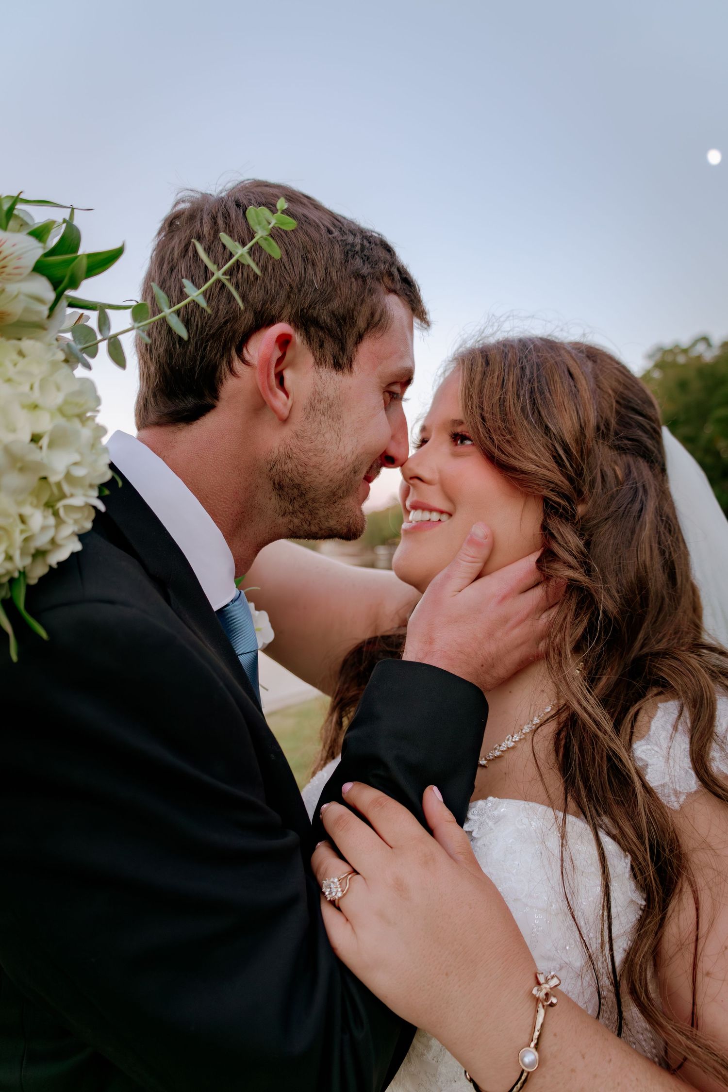 A romantic wedding photoshoot sequence showing tender moments between a couple in an outdoor setting.