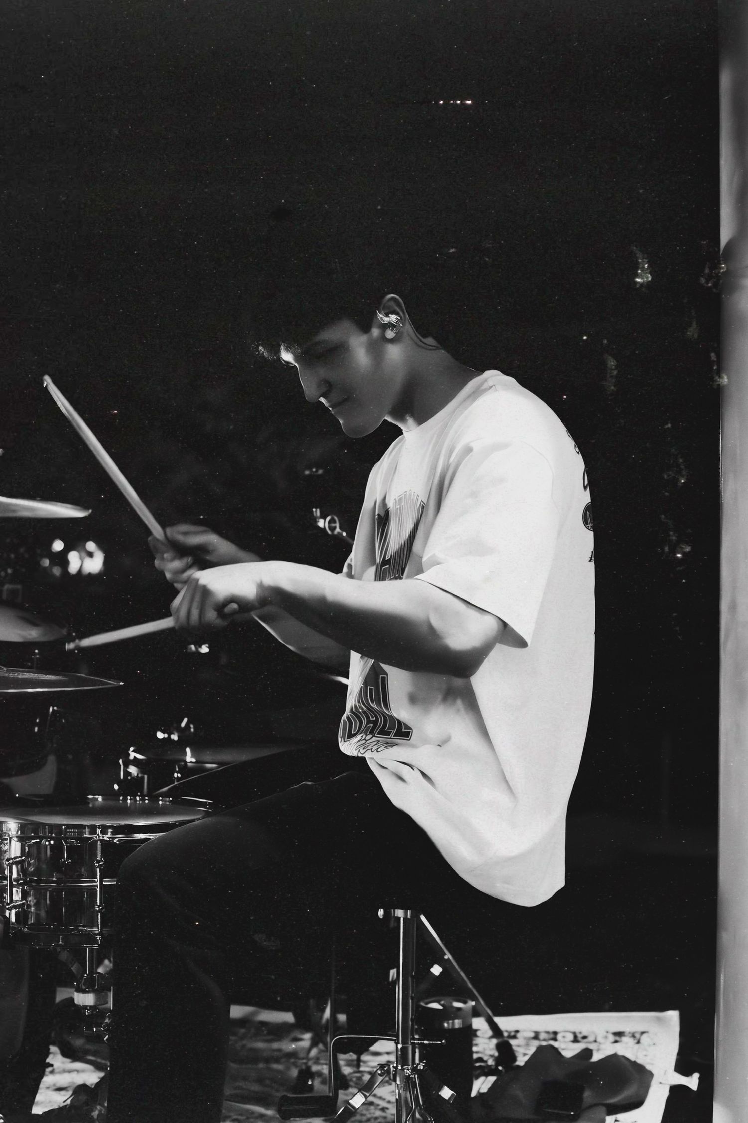 A dramatic black and white sequence of a drummer performing with dynamic motion.