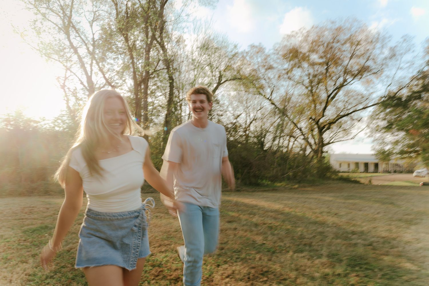 A romantic sunset photoshoot sequence showing a couple walking and laughing together in a park.