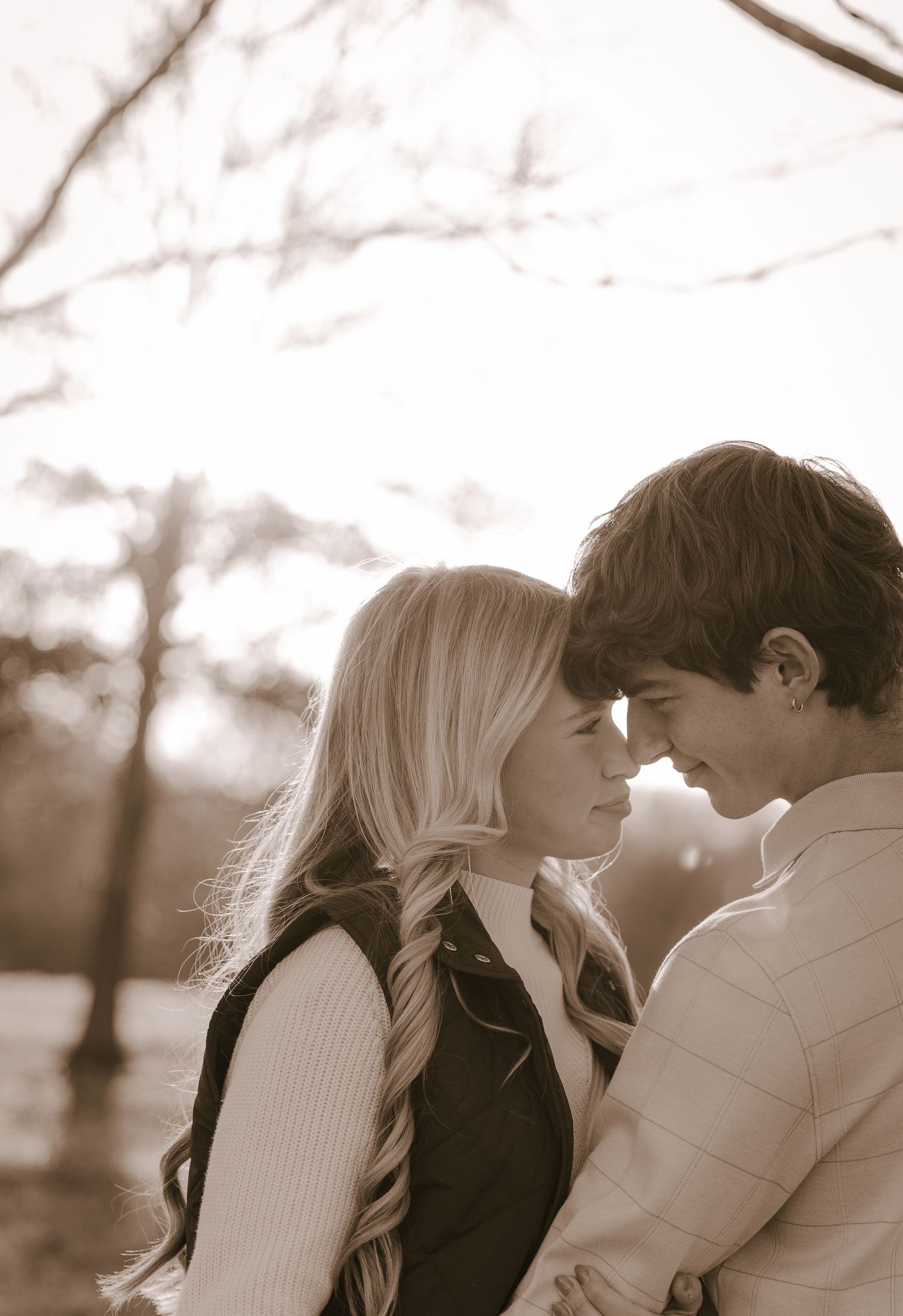 Intimate sepia-toned portrait sequence of a couple in winter clothing.