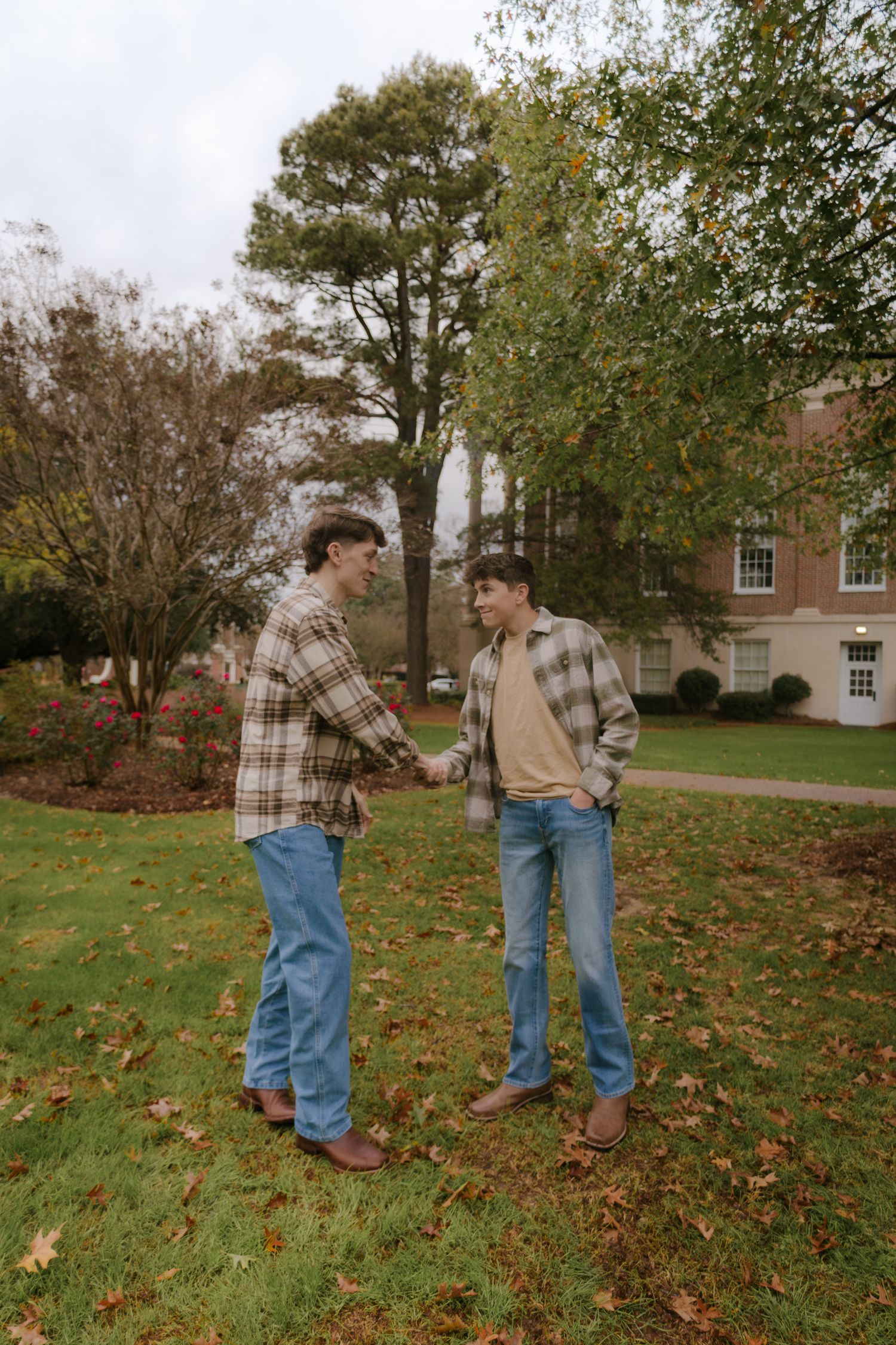 A playful autumn engagement photoshoot sequence showing a couple walking and interacting in fallen leaves.