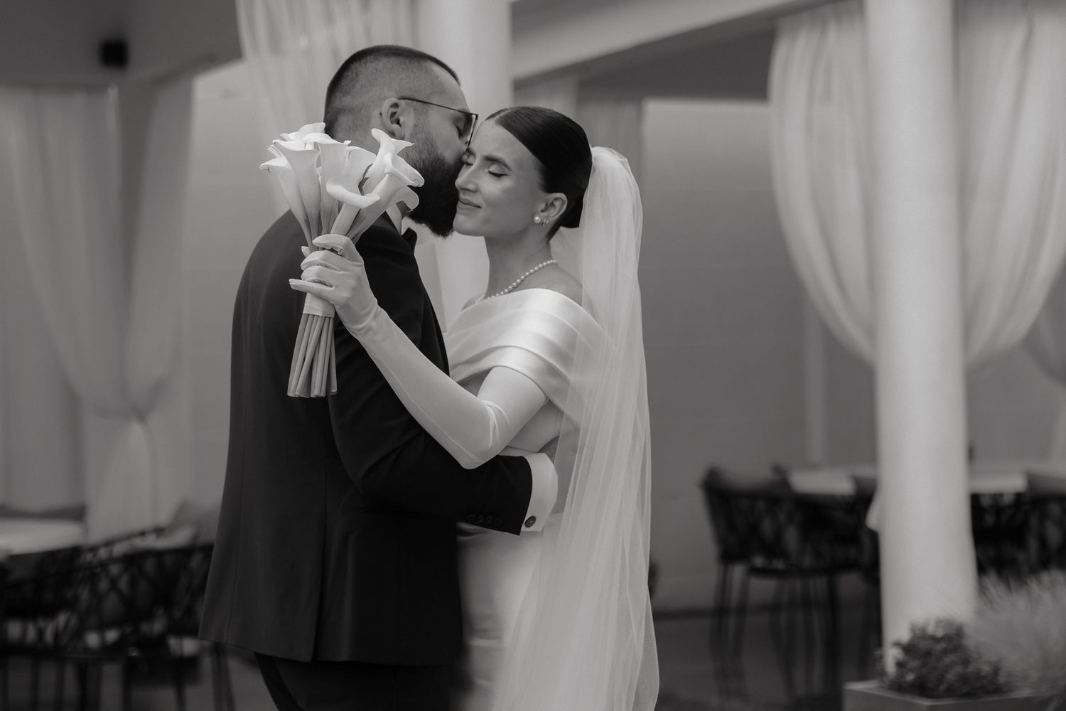 Black and white wedding photos showing couples dancing and embracing during romantic moments at a reception.