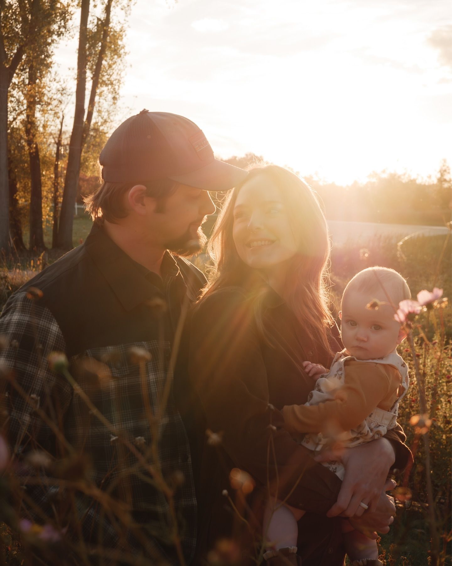 Family enjoying a golden sunset moment in nature.