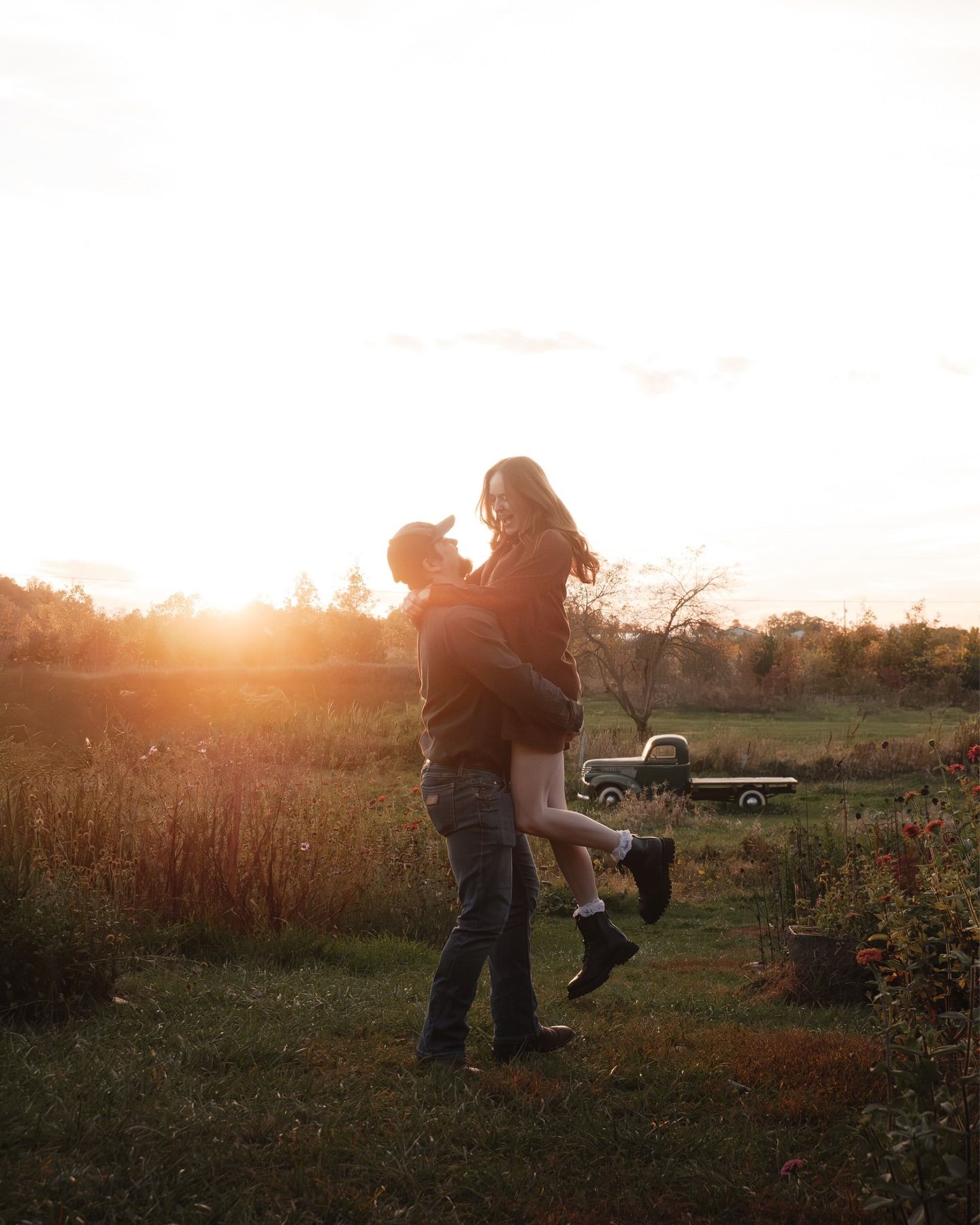 Silhouetted figures playing in a field during golden hour sunset.