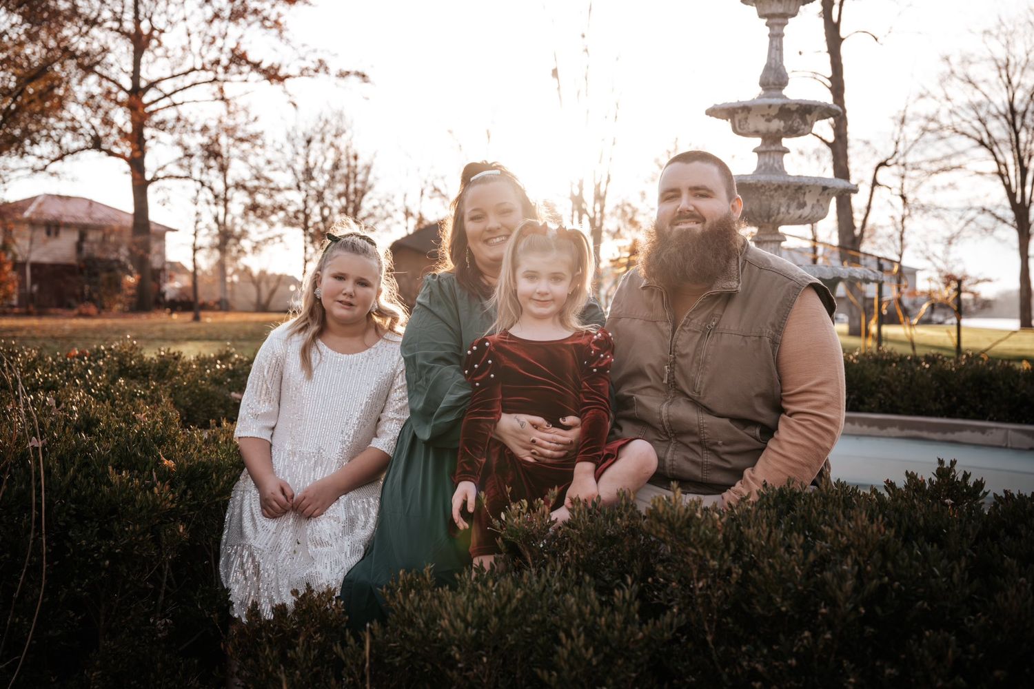 Family portrait session in a park during golden hour with natural lighting.