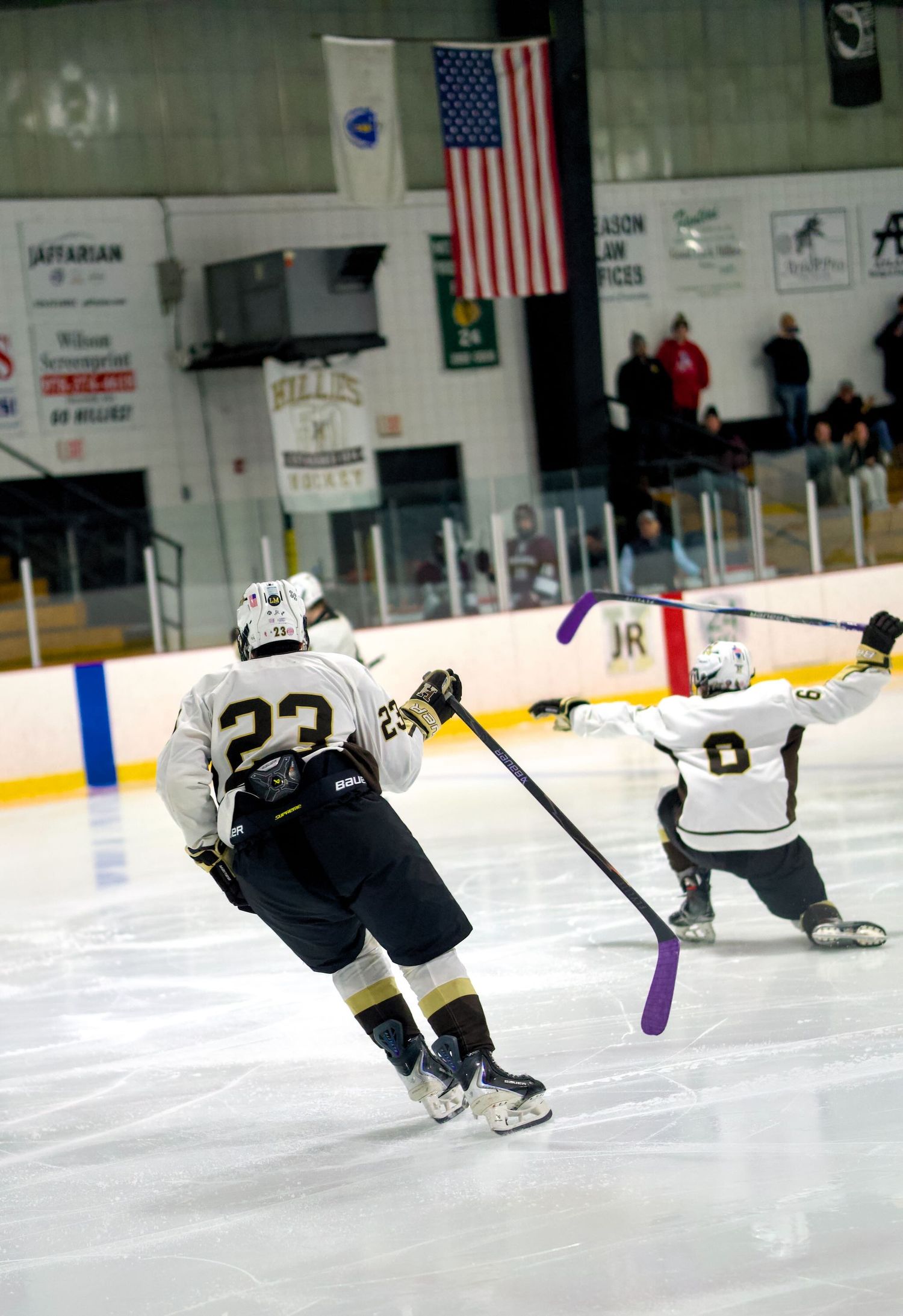 Haverhill hockey player celebrates by sliding on the ice.