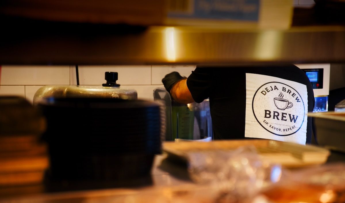 Coffee shop owner preparing a drink at Deja Brew in Salem, NH