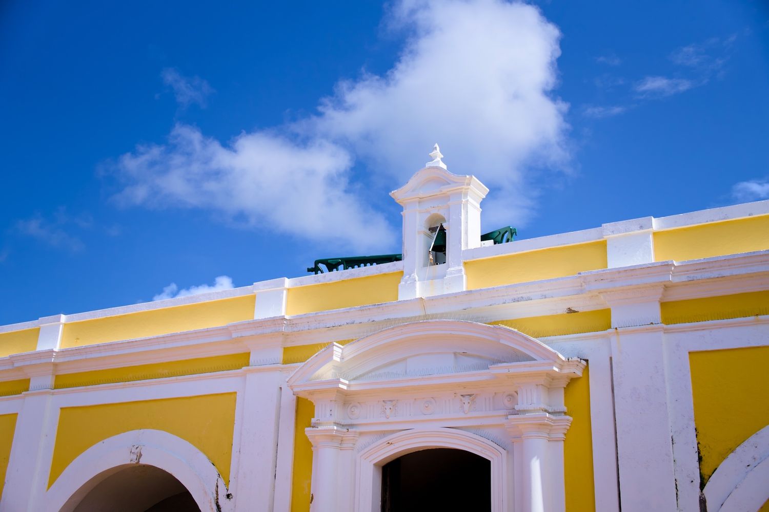 A yellow bell tower at an Old San Juan fort.