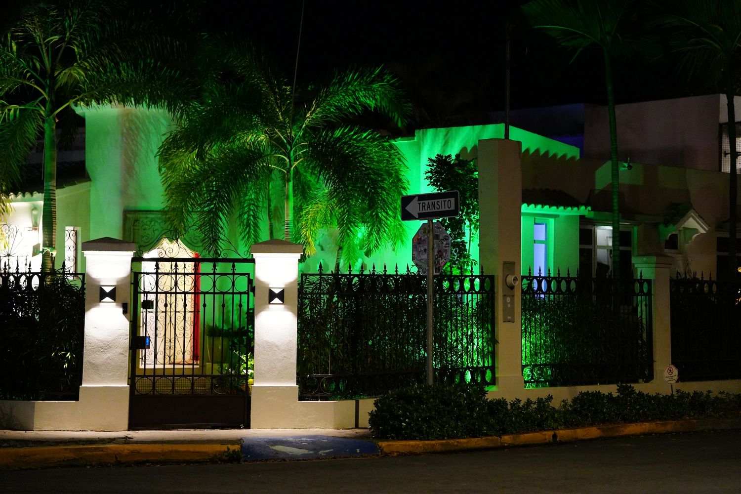 House at night lit up with green lights in San Juan.