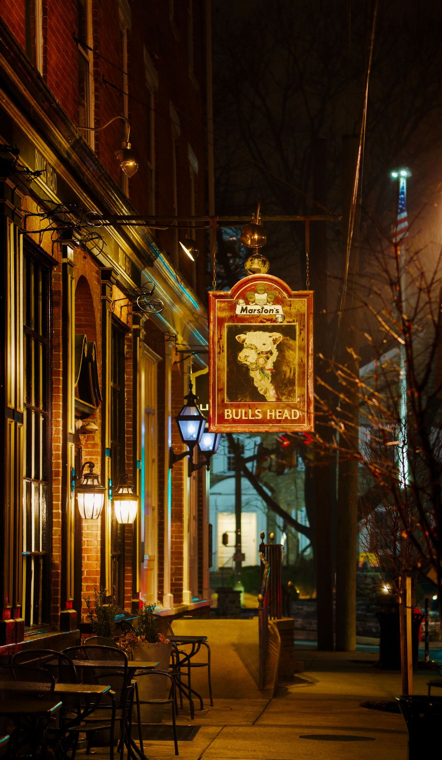 Pub sign along sidewalk in Lititz at night.