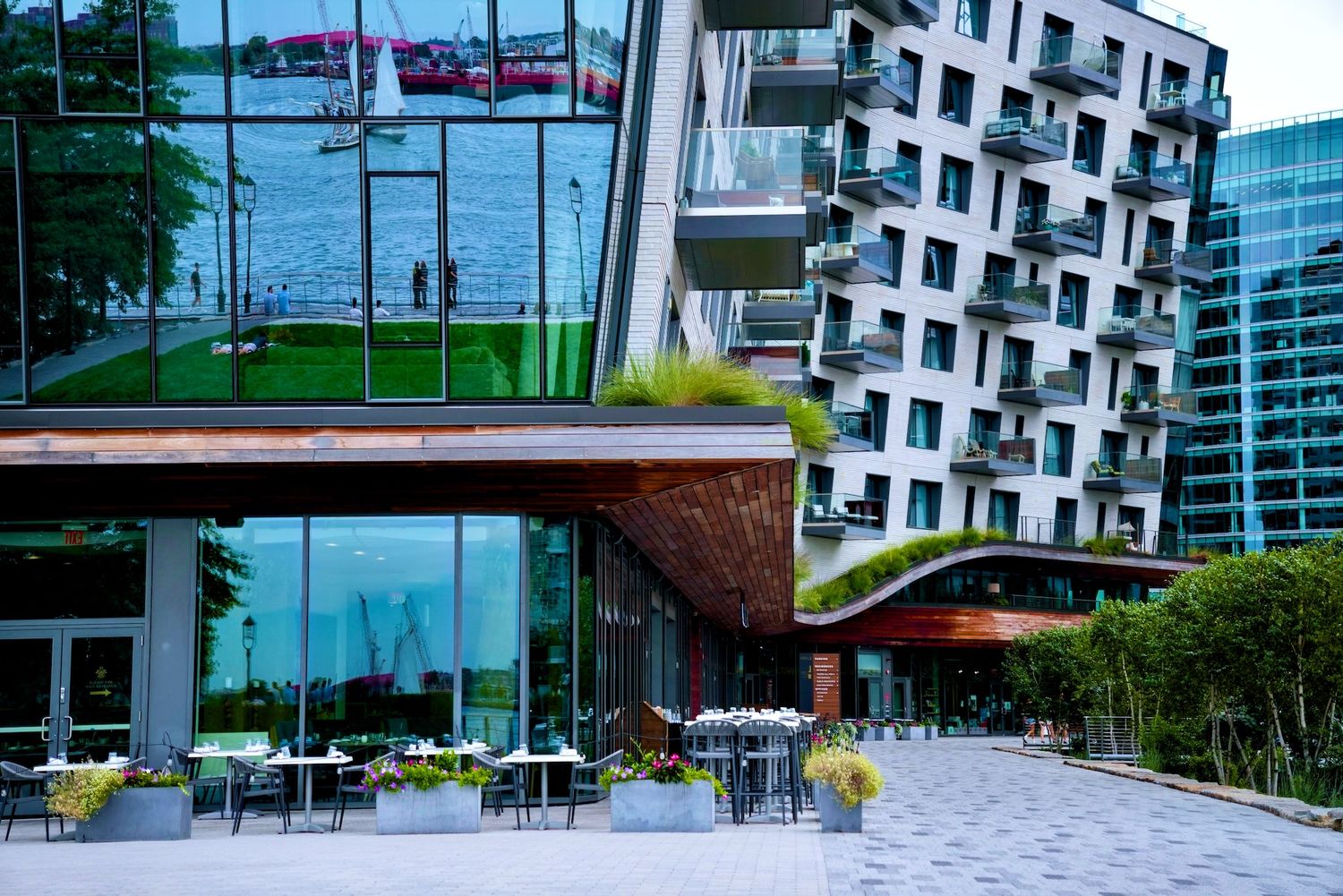 Winding contemporary building with glass reflecting Boston Harbor in Seaport.