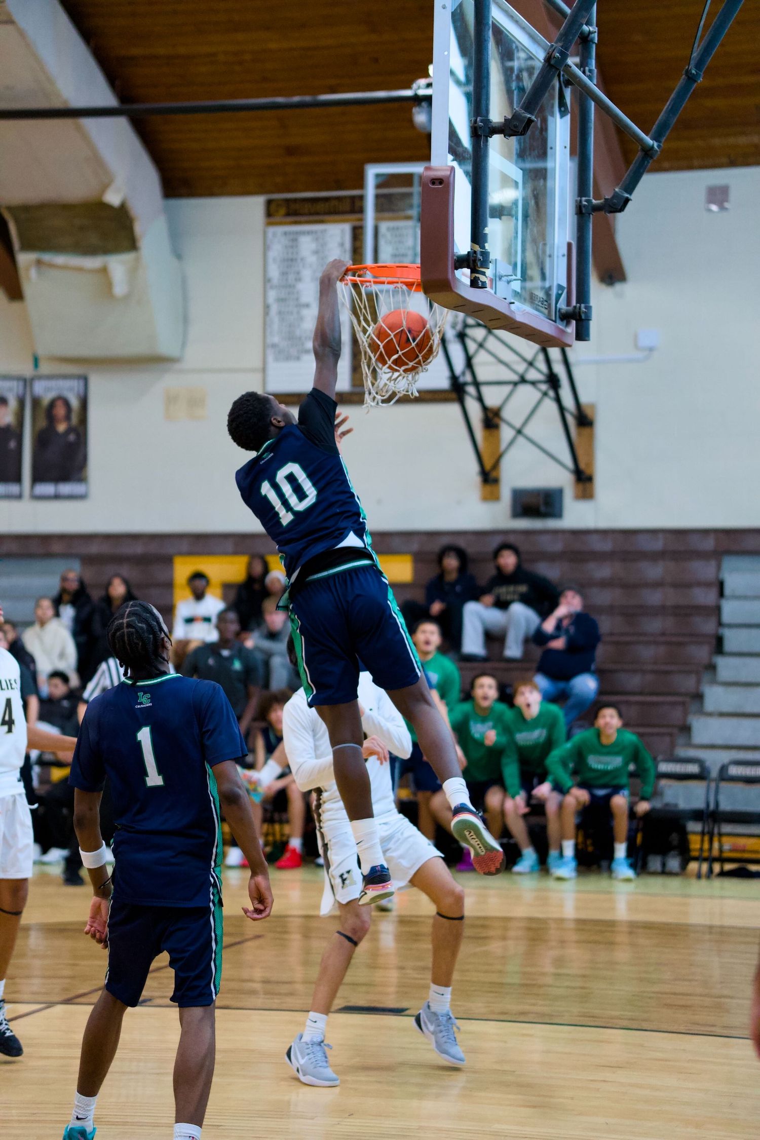Lowell Catholic basketball player dunks the ball.
