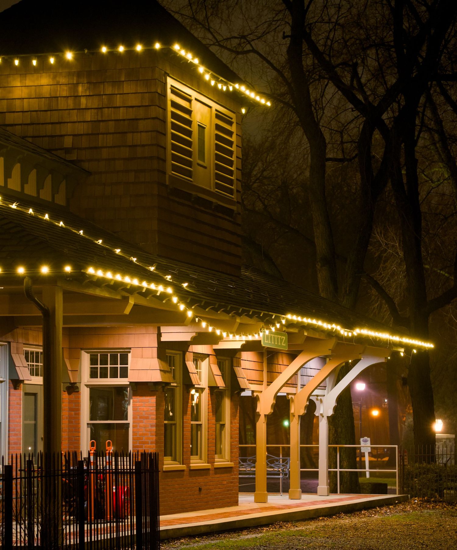 Exterior of old train station surrounded by lights in Lititz.