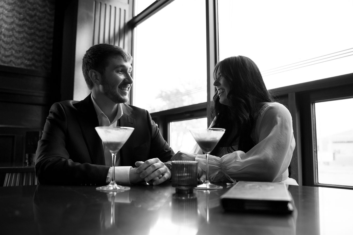 Couple toasting during a playful engagement photo session at a cozy Philadelphia cocktail bar-4.jpg