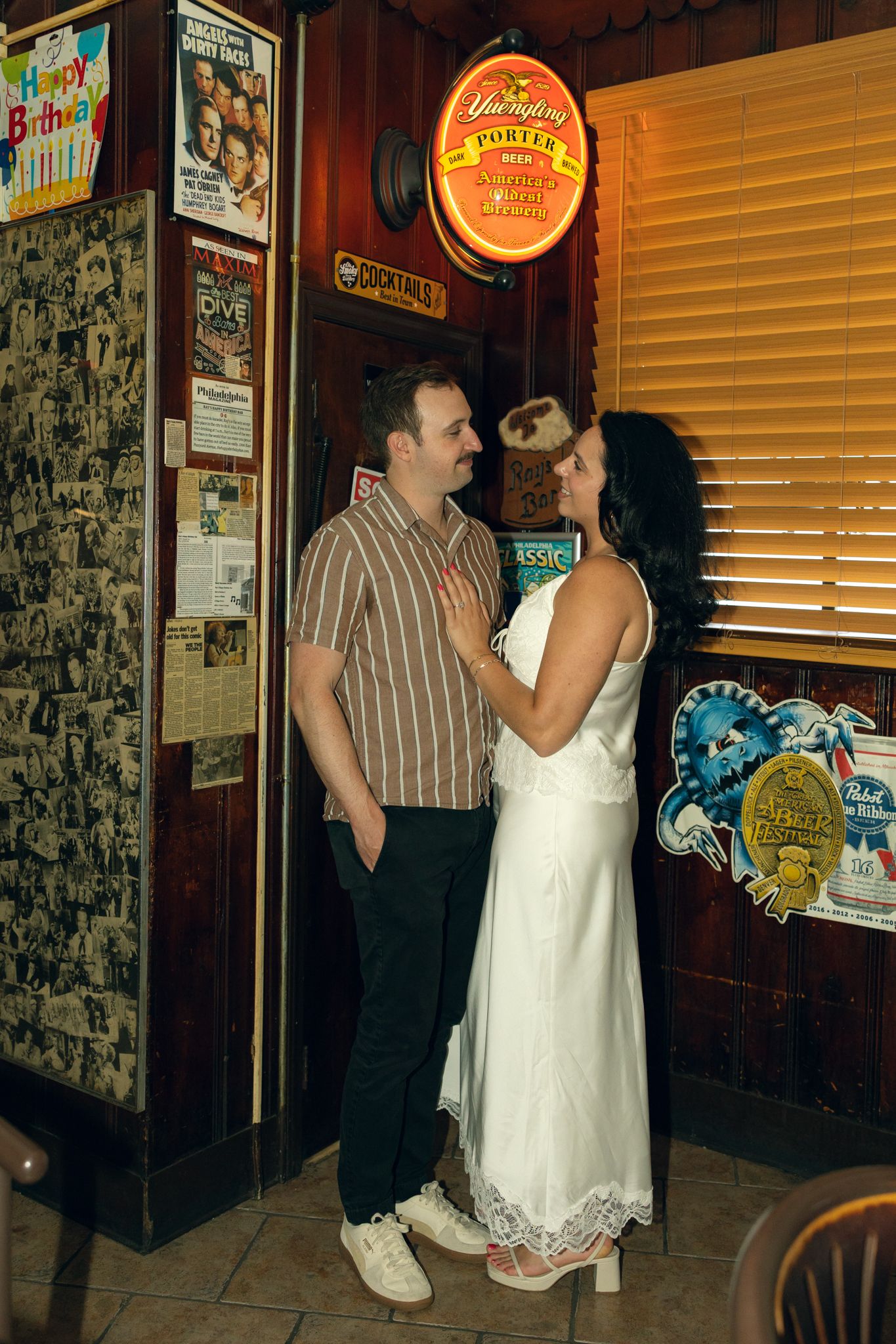 Couple toasting during a playful engagement photo session at a cozy Philadelphia cocktail bar-4.jpg