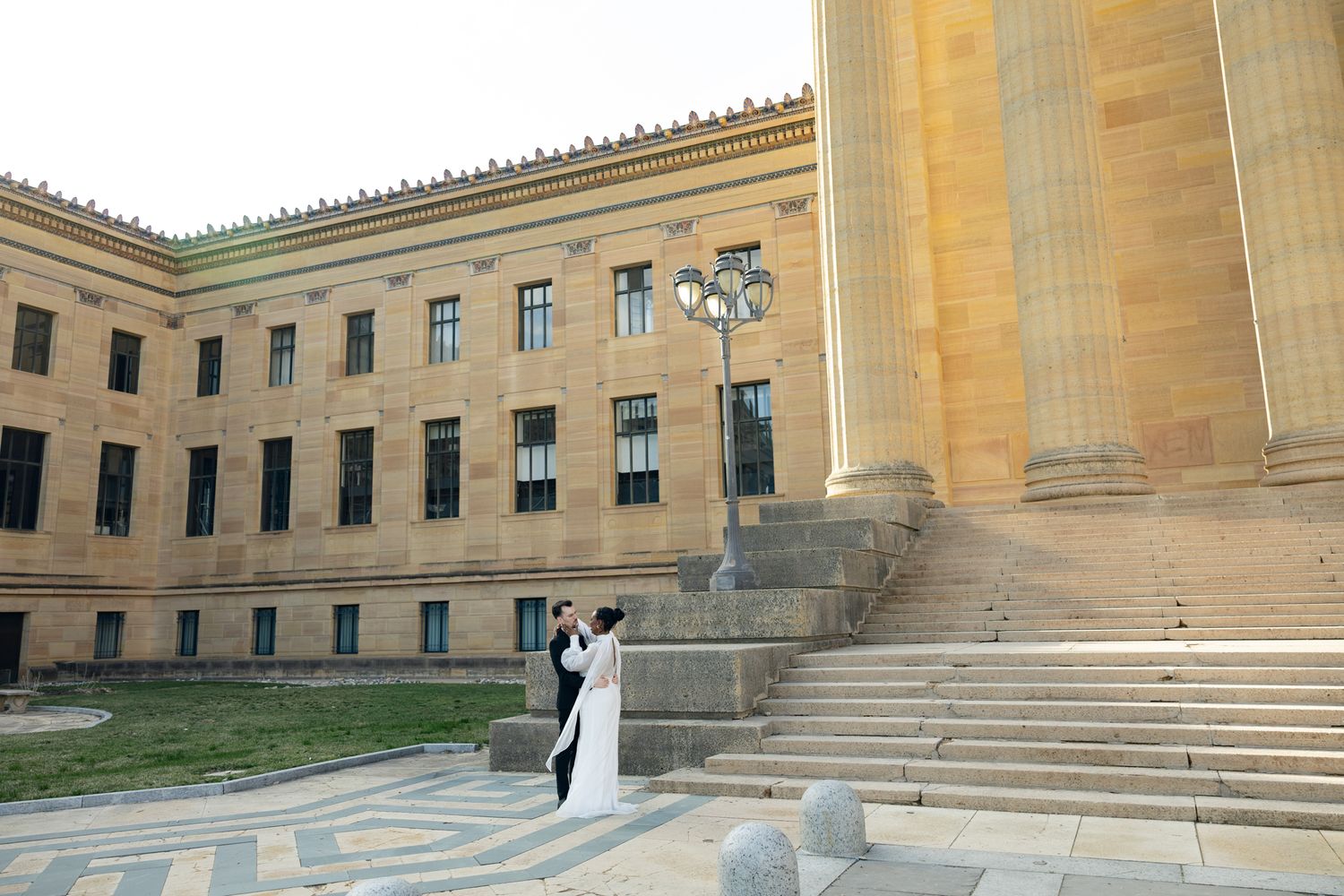 Editorial wedding photography of a bridal couple at the Philadelphia Museum of Art, modern romantic portraits with architectural backdrop