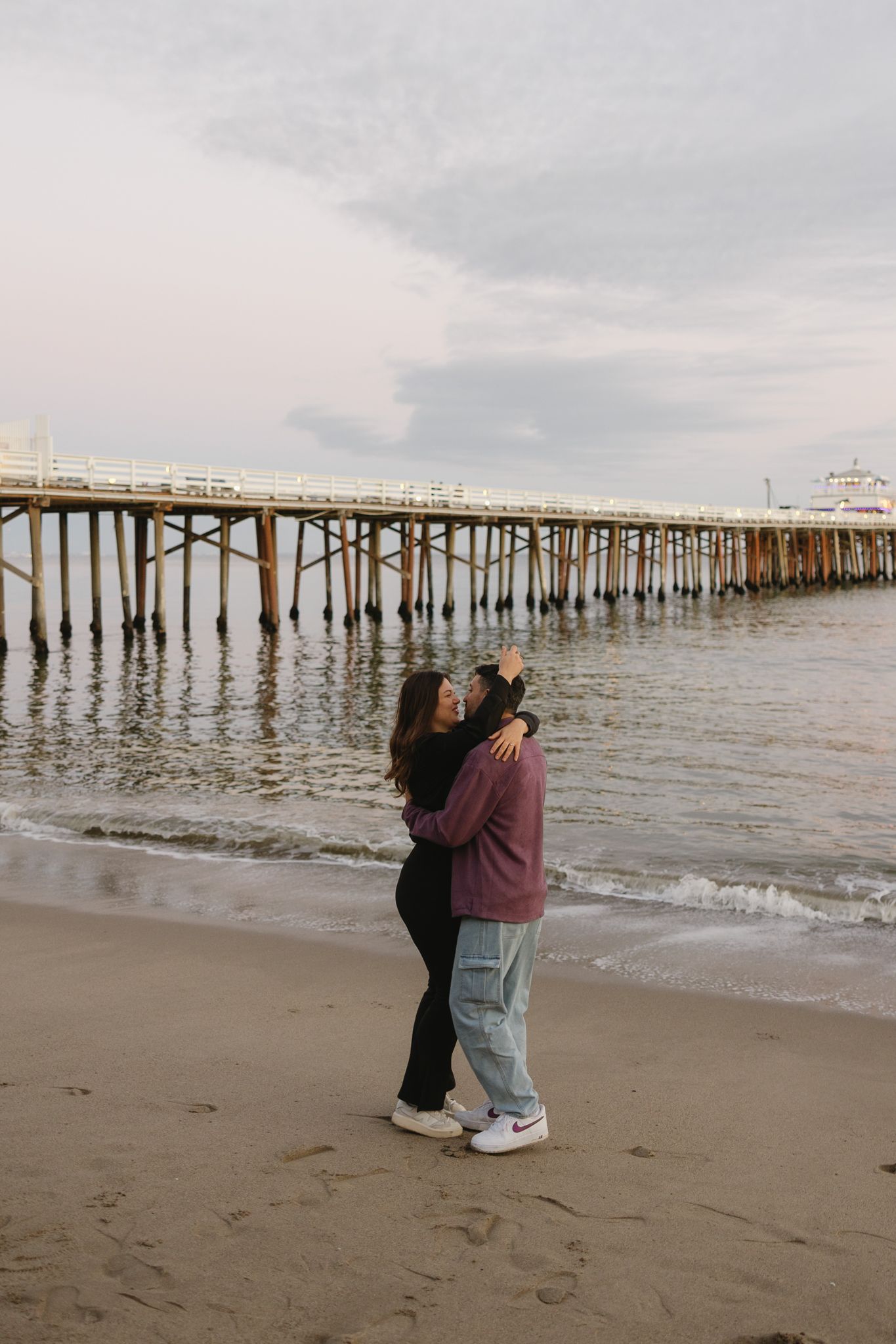 Ocean City NJ engagement photos on the boardwalk with candid moments