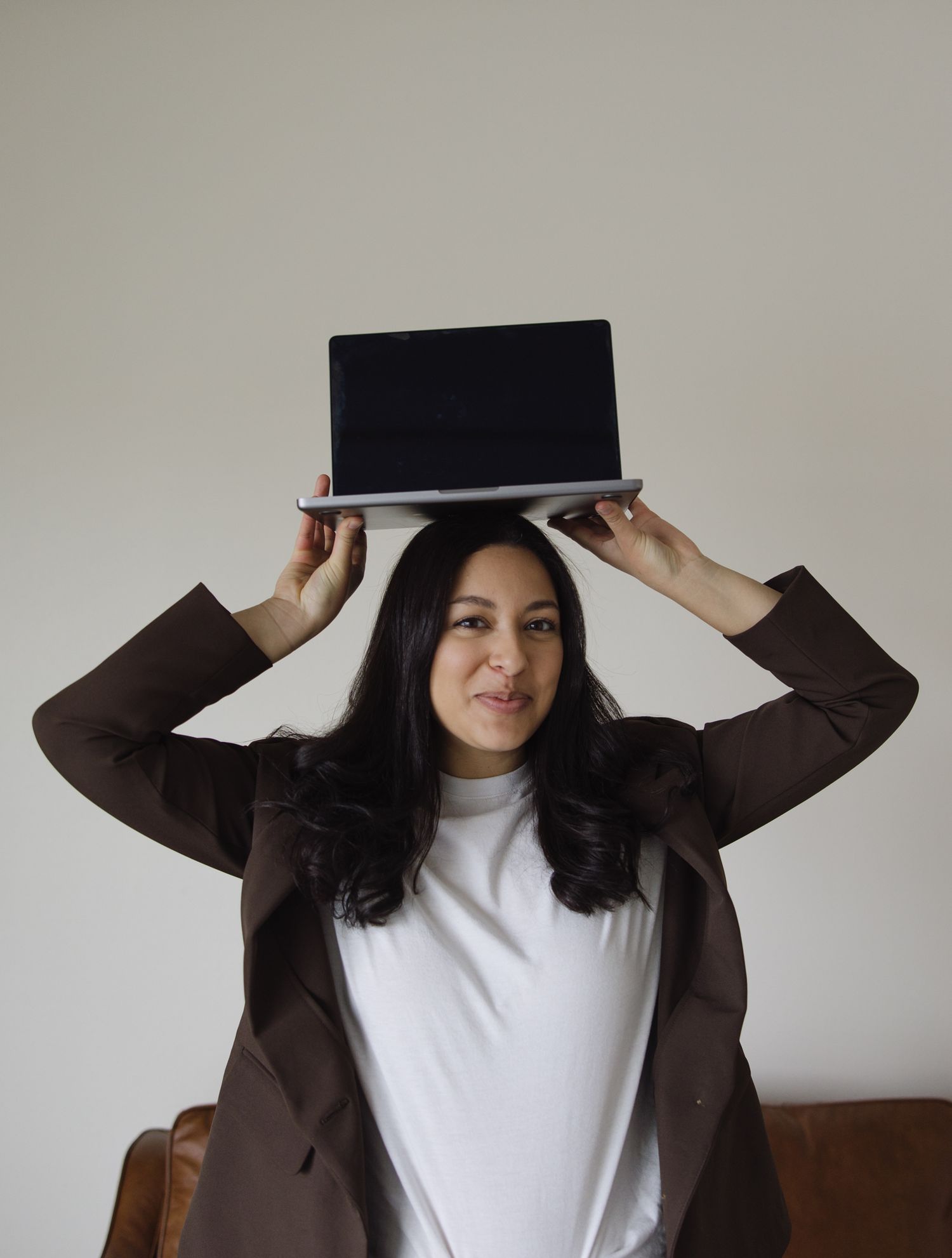 Brand photography in Philadelphia with a small business owner working on a laptop, styled desk details, and candid moments