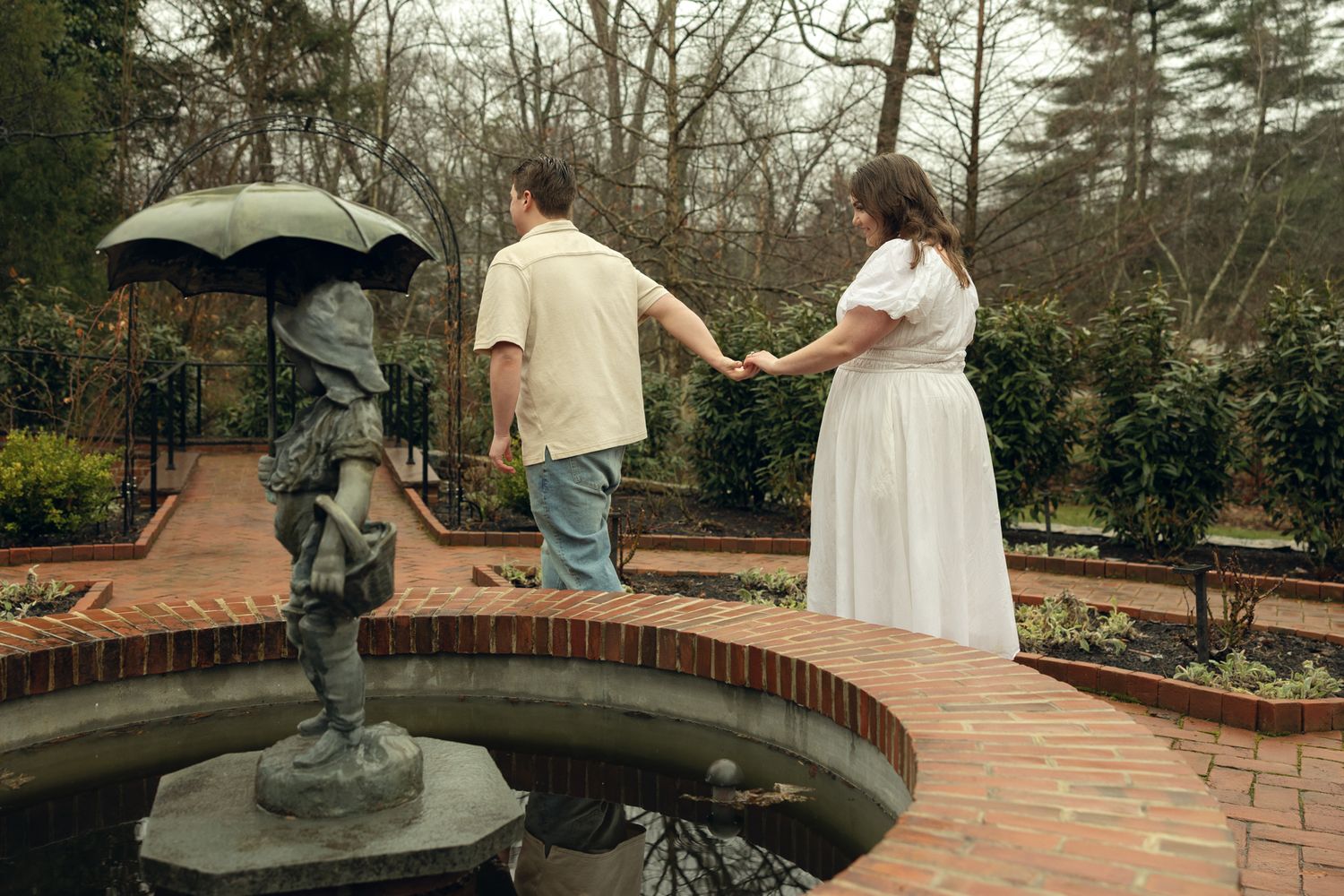 Romantic engagement photos at Appleford Estate near Philadelphia featuring a couple walking through lush gardens and historic architecture